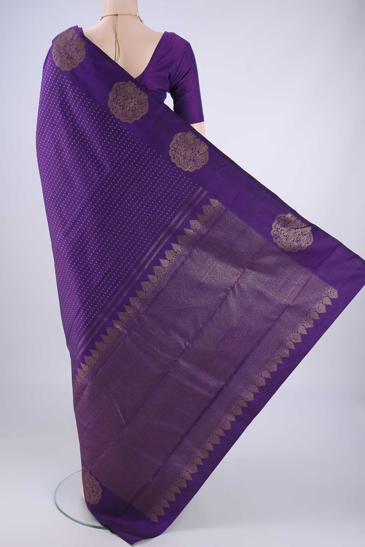 Flat view of Purple Kanchipuram Silk Saree with Zari Butta on the body and Fancy Border. 