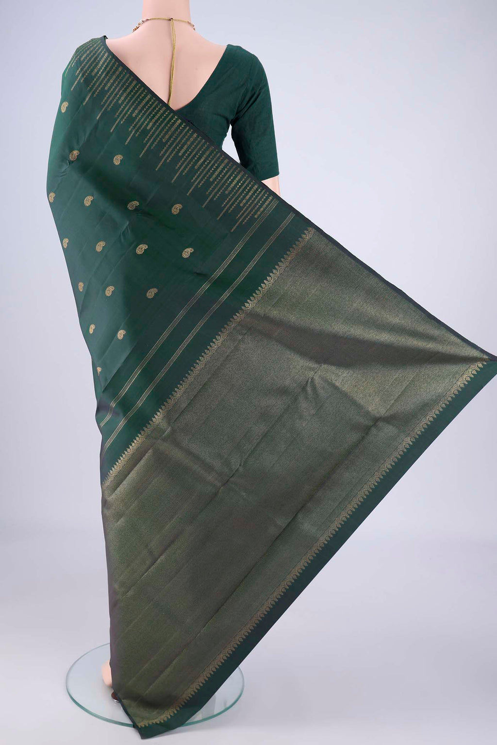 Flat view of Pure Silk Pure Zari Bottle Green Kanchipuram Saree with Zari Butta on the body and Zari Border. 