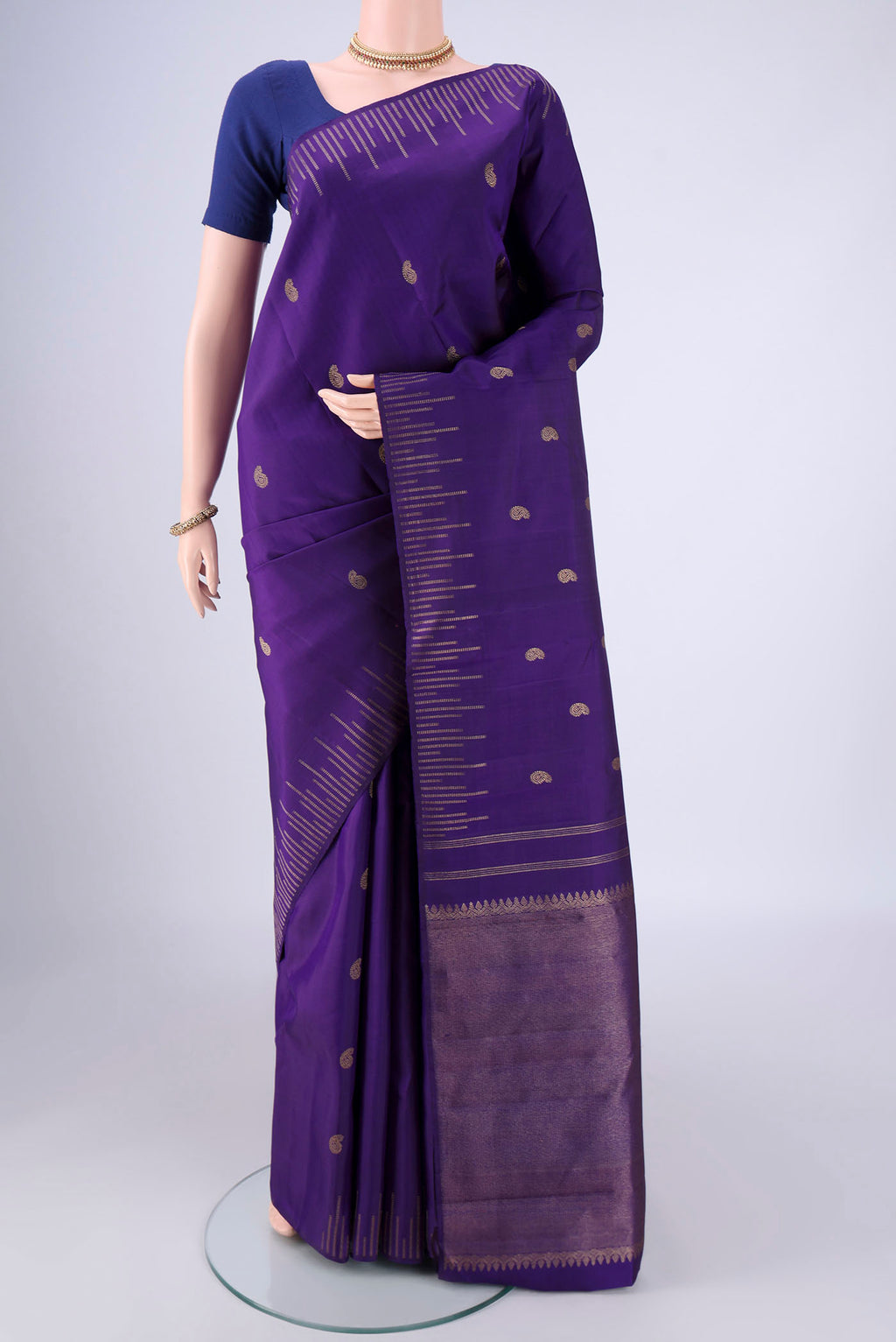 Pure Silk Pure Zari Violet Kanchipuram Saree with Zari Butta on the body and Plain Border.  displayed on a mannequin