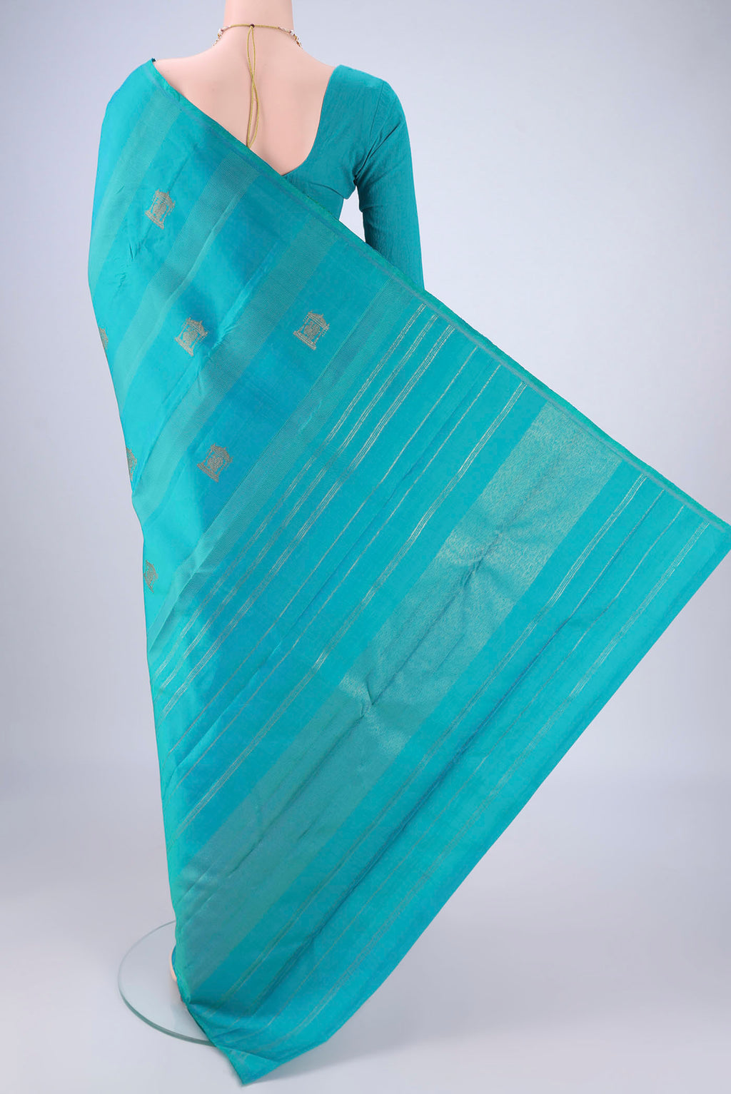 Flat view of Pure Silk Pure Zari Turquoise Kanjivaram Saree with Zari Butta on the body and Without Border. 