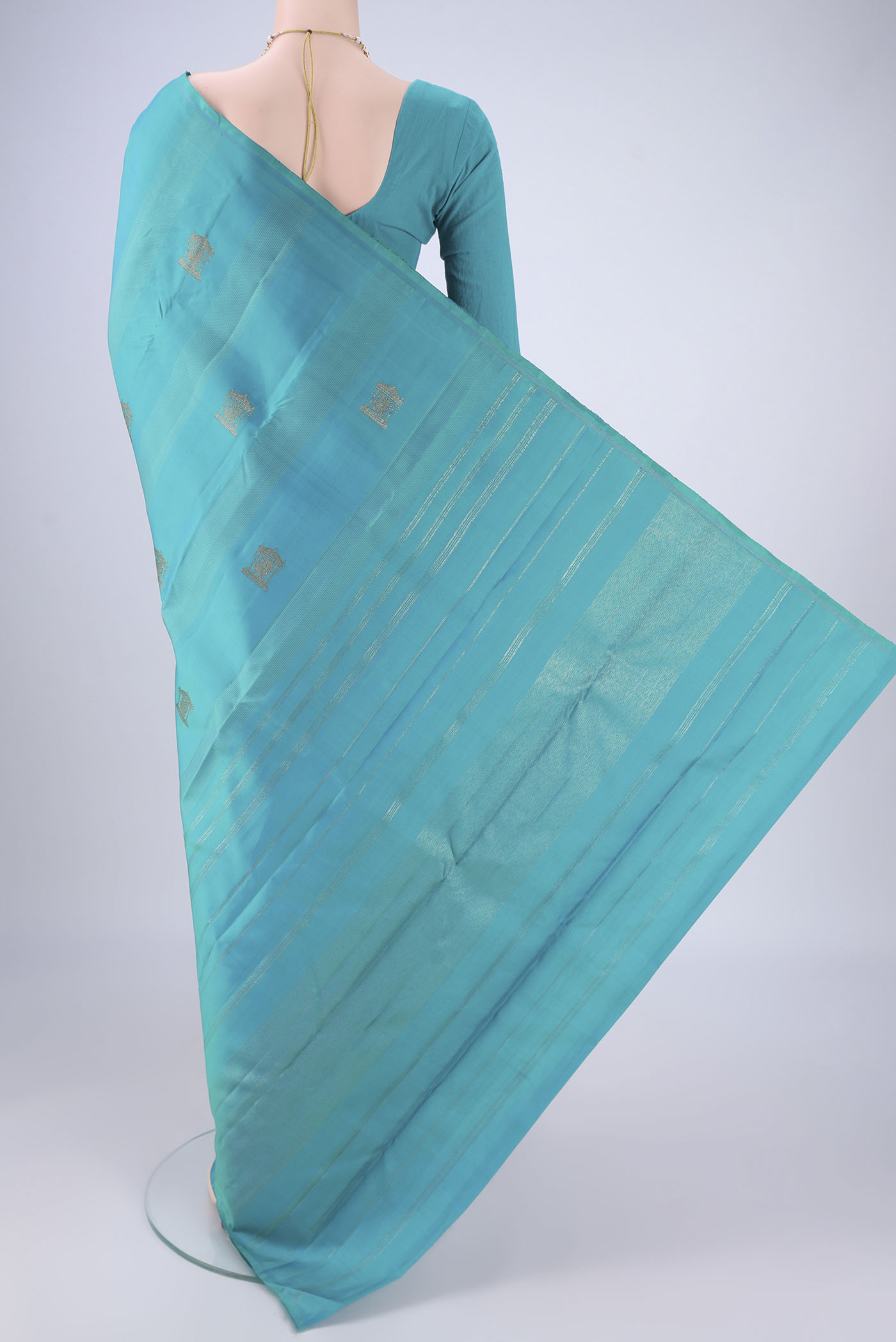 Flat view of Pure Silk Pure Zari Turquoise Kanjivaram Saree with Zari Butta on the body and Without Border. 