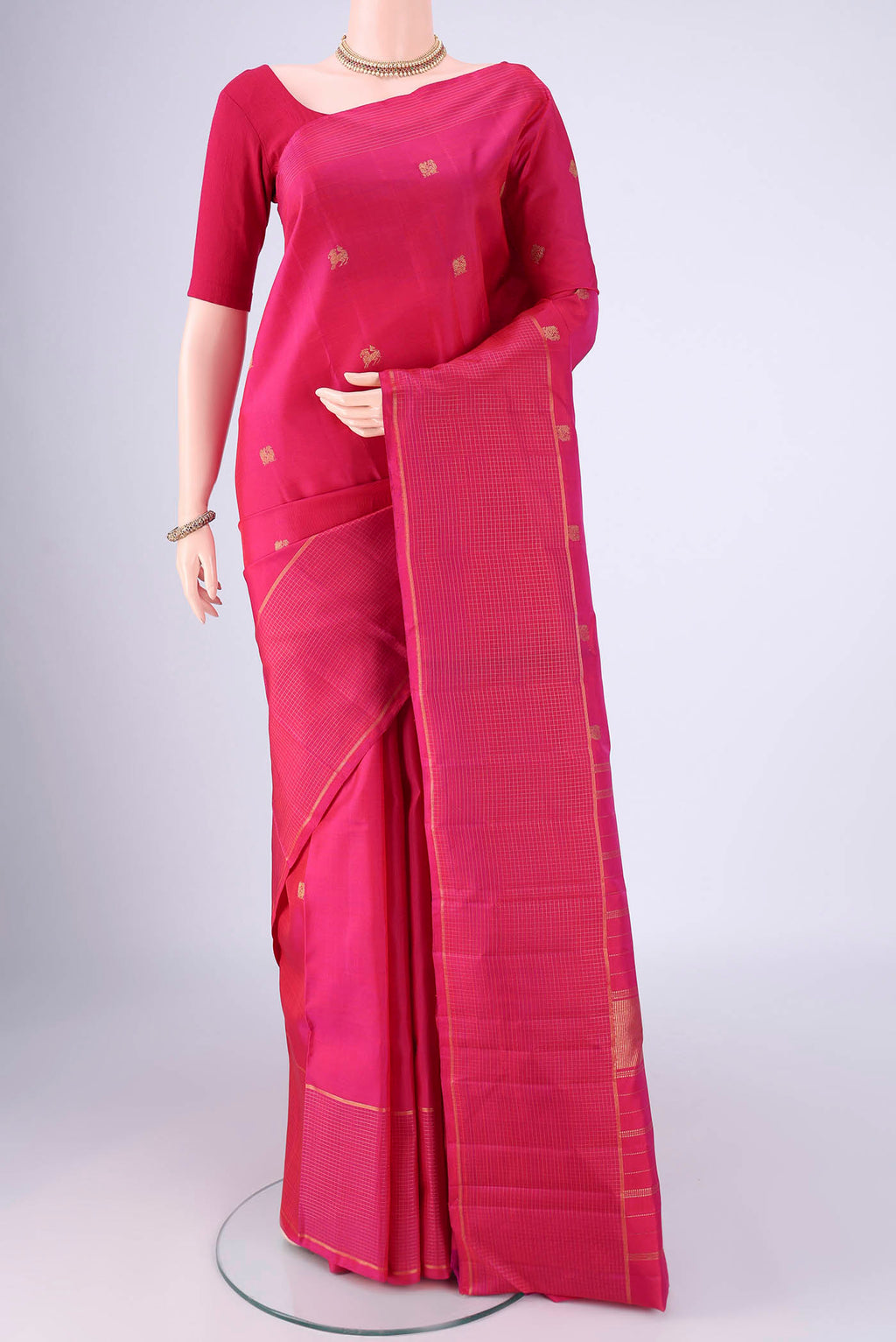 Pure Silk Pure Zari Dark Pink Kanchipuram Saree with Zari Butta on the body and Zari Border.  displayed on a mannequin