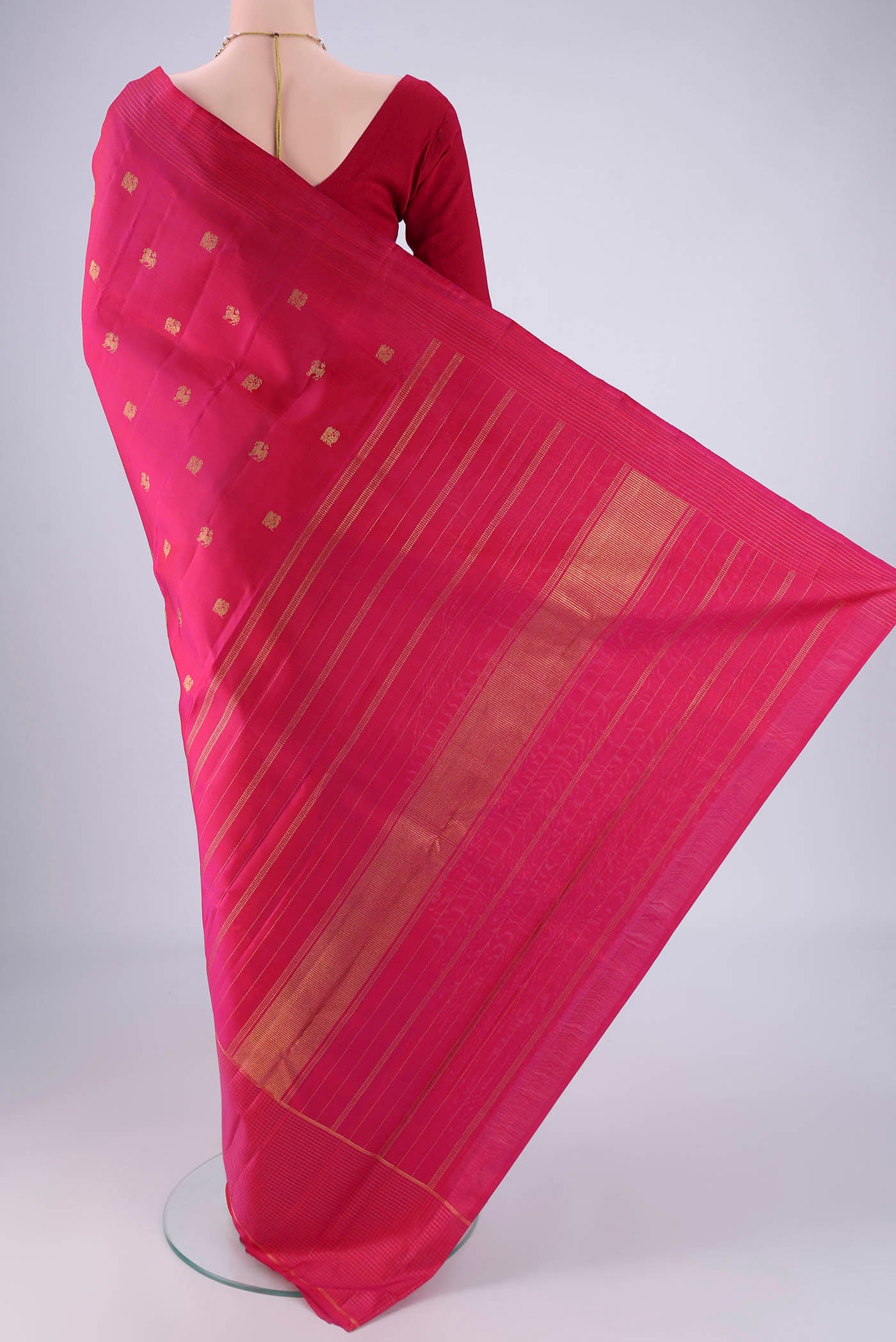 Flat view of Pure Silk Pure Zari Dark Pink Kanchipuram Saree with Zari Butta on the body and Zari Border. 