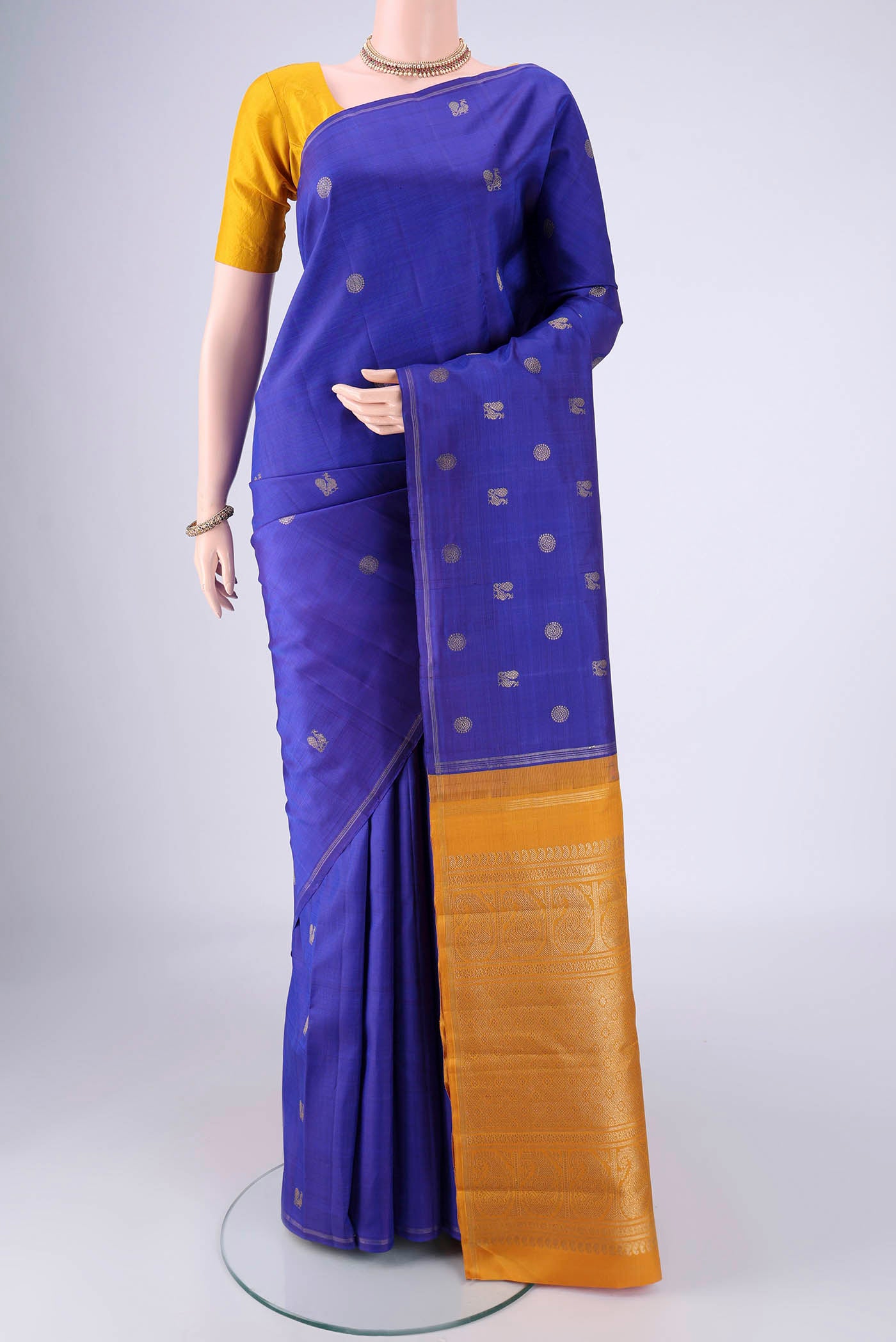 Pure Silk Pure Zari Royal Blue Kanchipuram Saree with Zari Butta on the body and Zari Border.  displayed on a mannequin