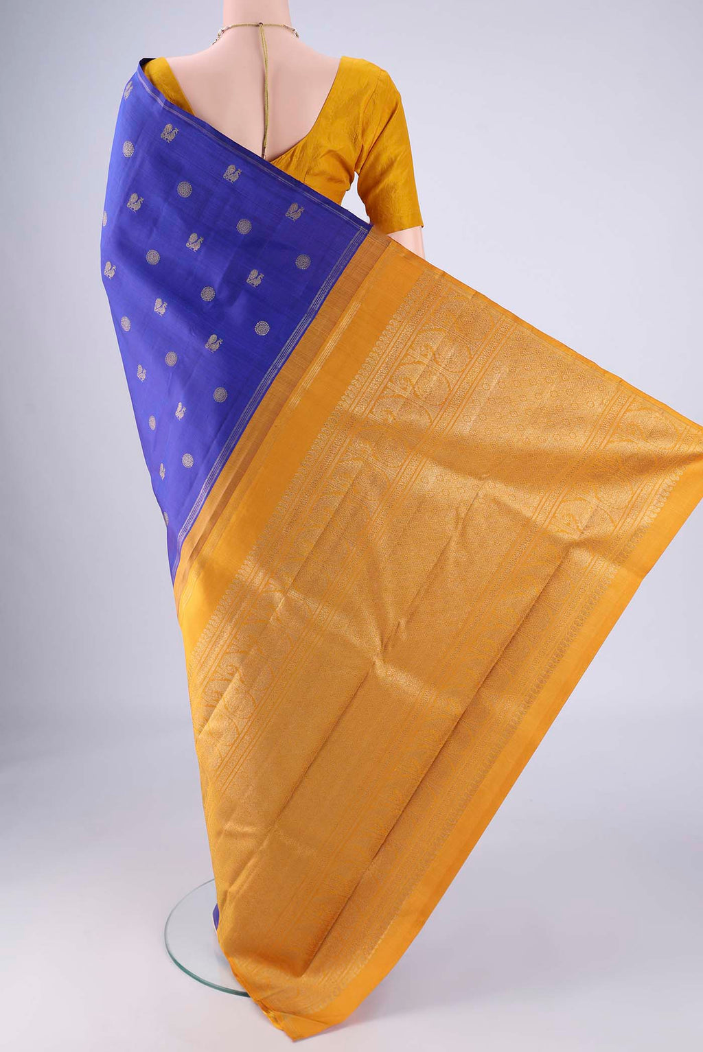 Flat view of Pure Silk Pure Zari Royal Blue Kanchipuram Saree with Zari Butta on the body and Zari Border. 