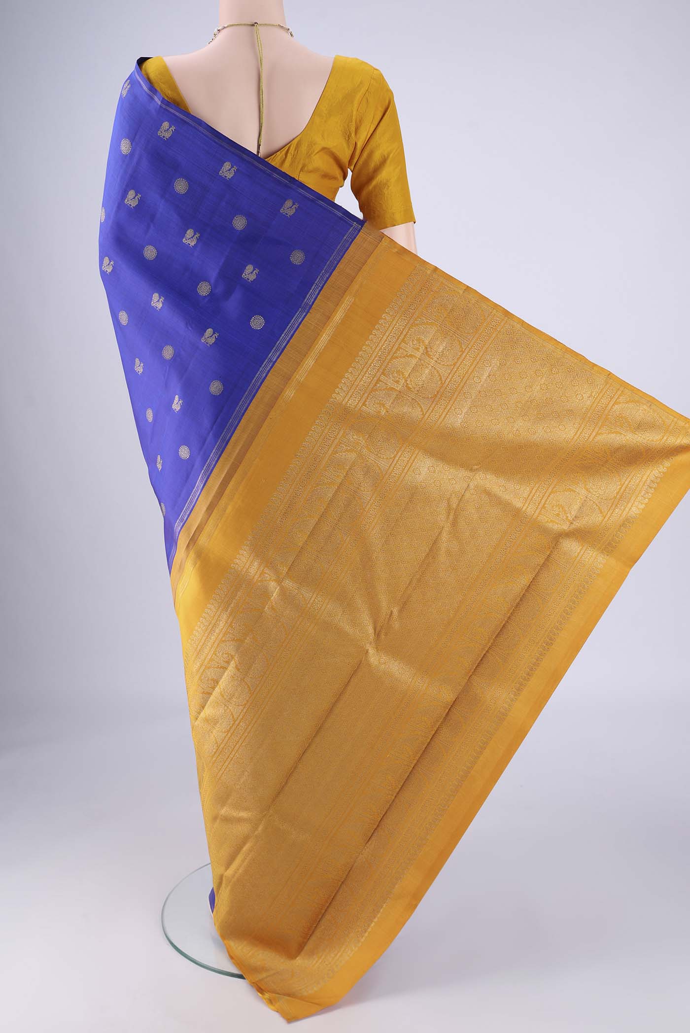 Flat view of Pure Silk Pure Zari Royal Blue Kanchipuram Saree with Zari Butta on the body and Zari Border. 