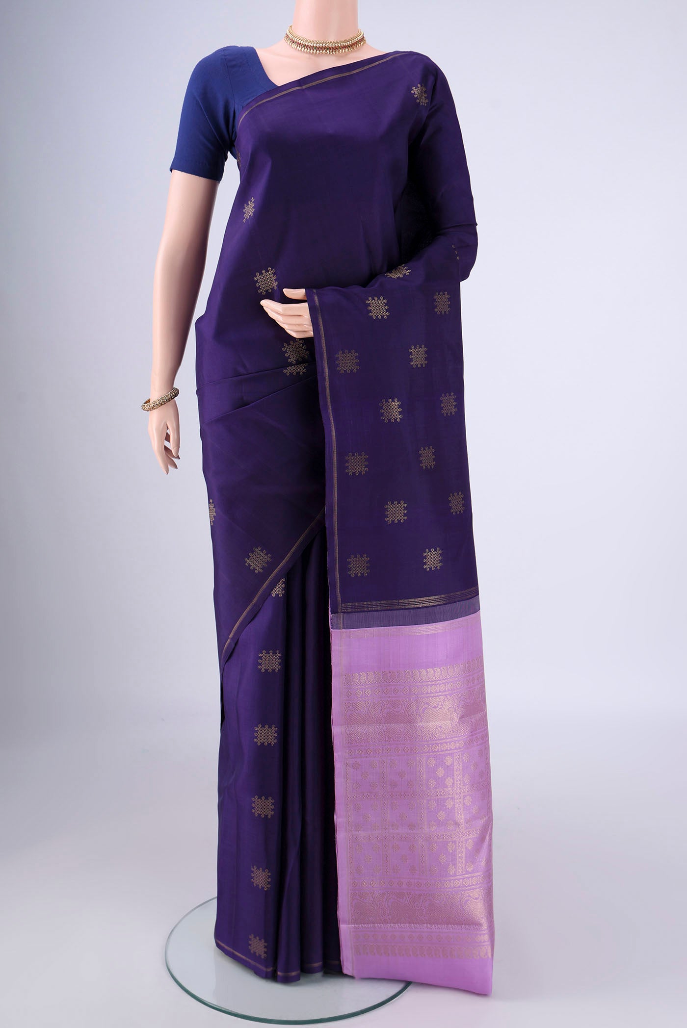 Pure Silk Pure Zari Navy Blue Kanchipuram Saree with Zari Butta on the body and Plain Border.  displayed on a mannequin