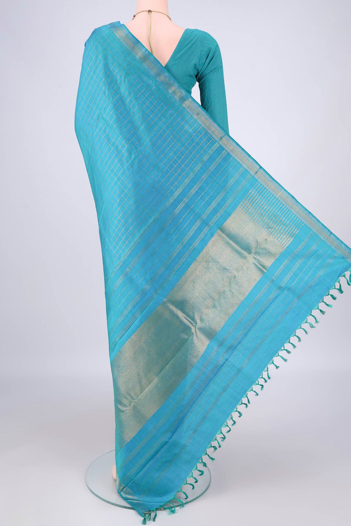 Flat view of Pure Silk Pure Zari Light Blue Kanchipuram Saree with Checked design on the body and Zari Border. 