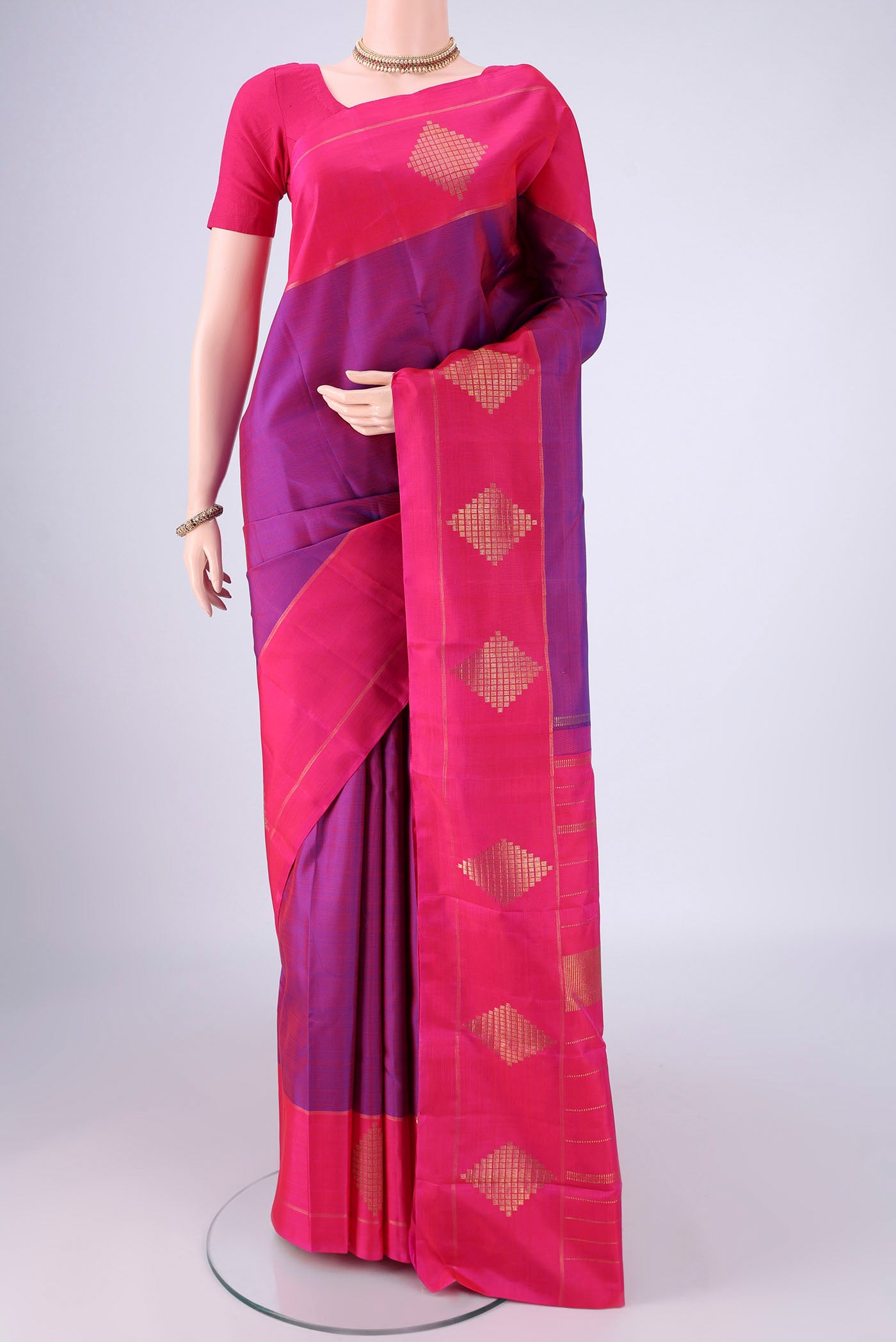 Purple Kanchipuram Silk Saree with Zari Butta on the body and Zari Border.  displayed on a mannequin