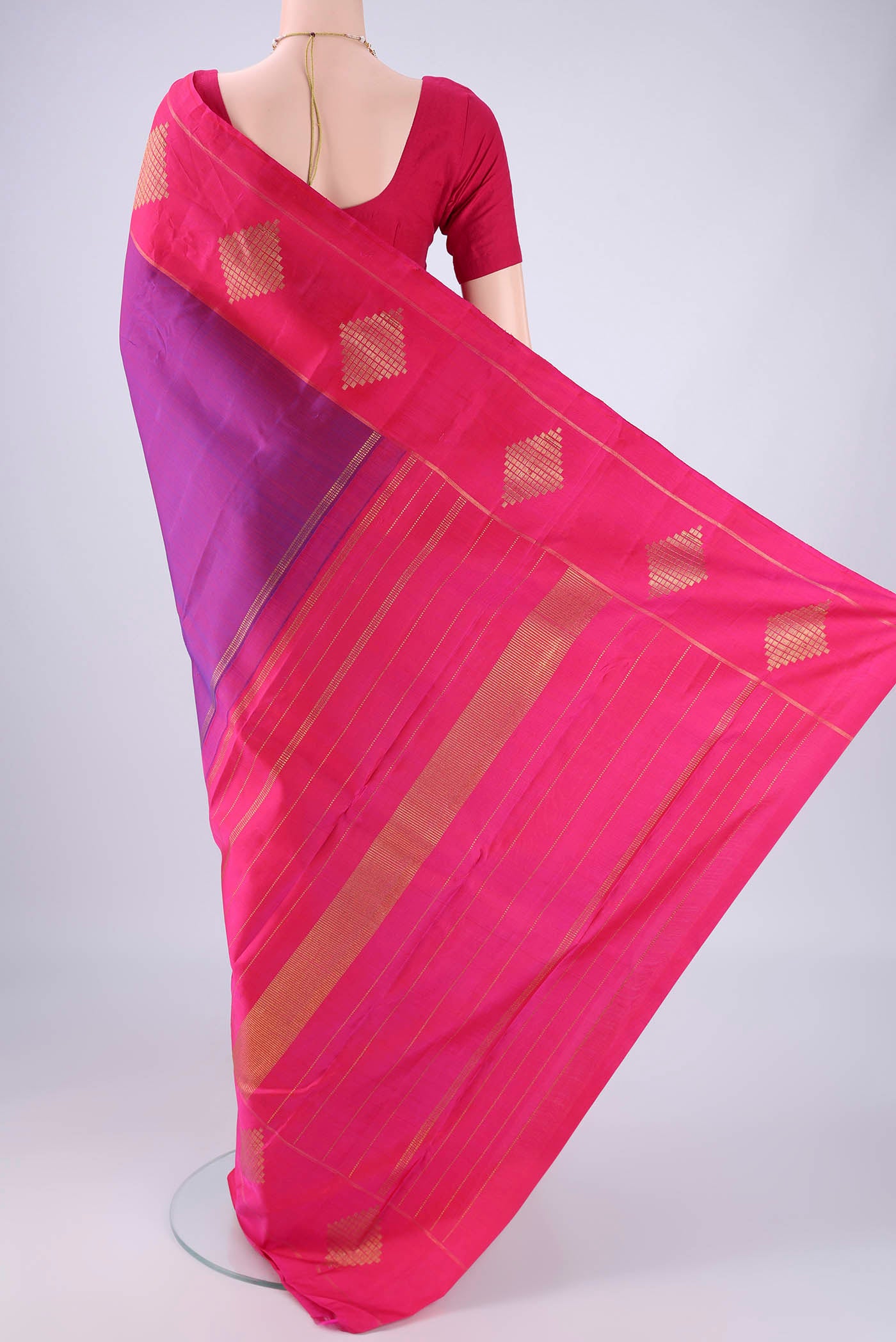 Flat view of Purple Kanchipuram Silk Saree with Zari Butta on the body and Zari Border. 