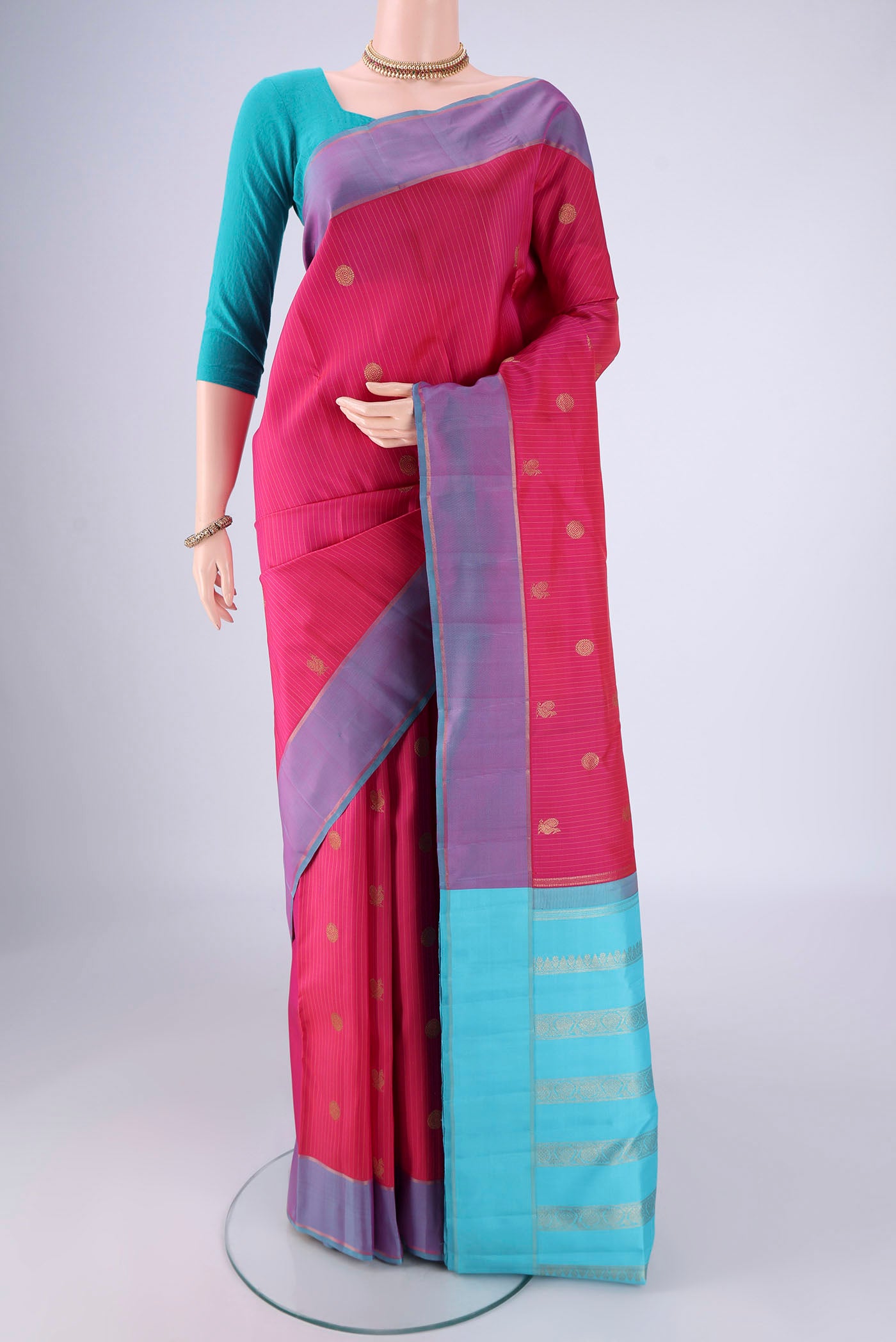 Dark Pink Kanjivaram Silk Saree with Zari Butta on the body and Zari Border.  displayed on a mannequin