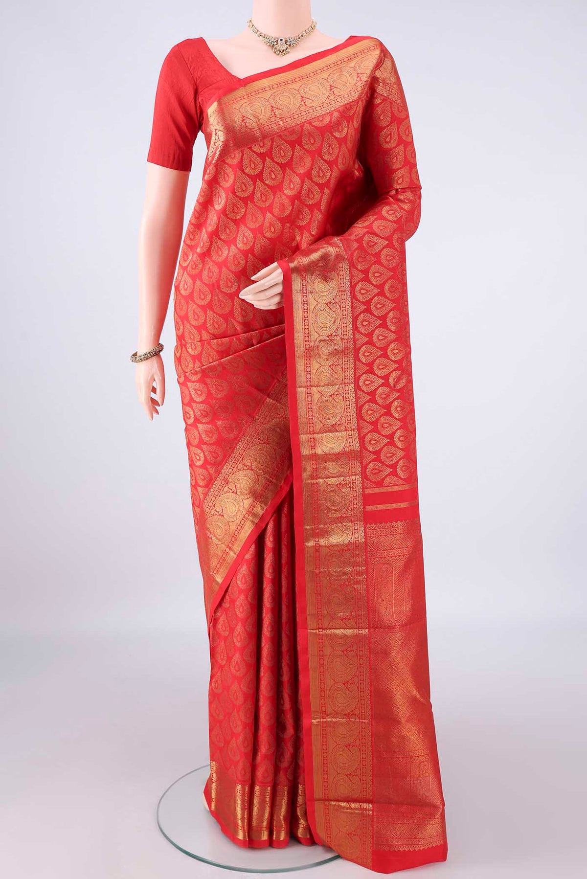 Pure Silk Red Kanchipuram Saree with Zari Brocade on the body and Zari Border.  displayed on a mannequin