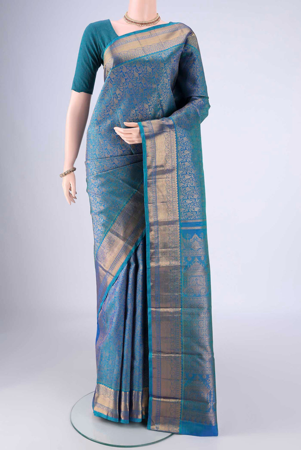 Peacock Blue Kanchipuram Silk Saree with Zari Brocade on the body and Zari Border.  displayed on a mannequin