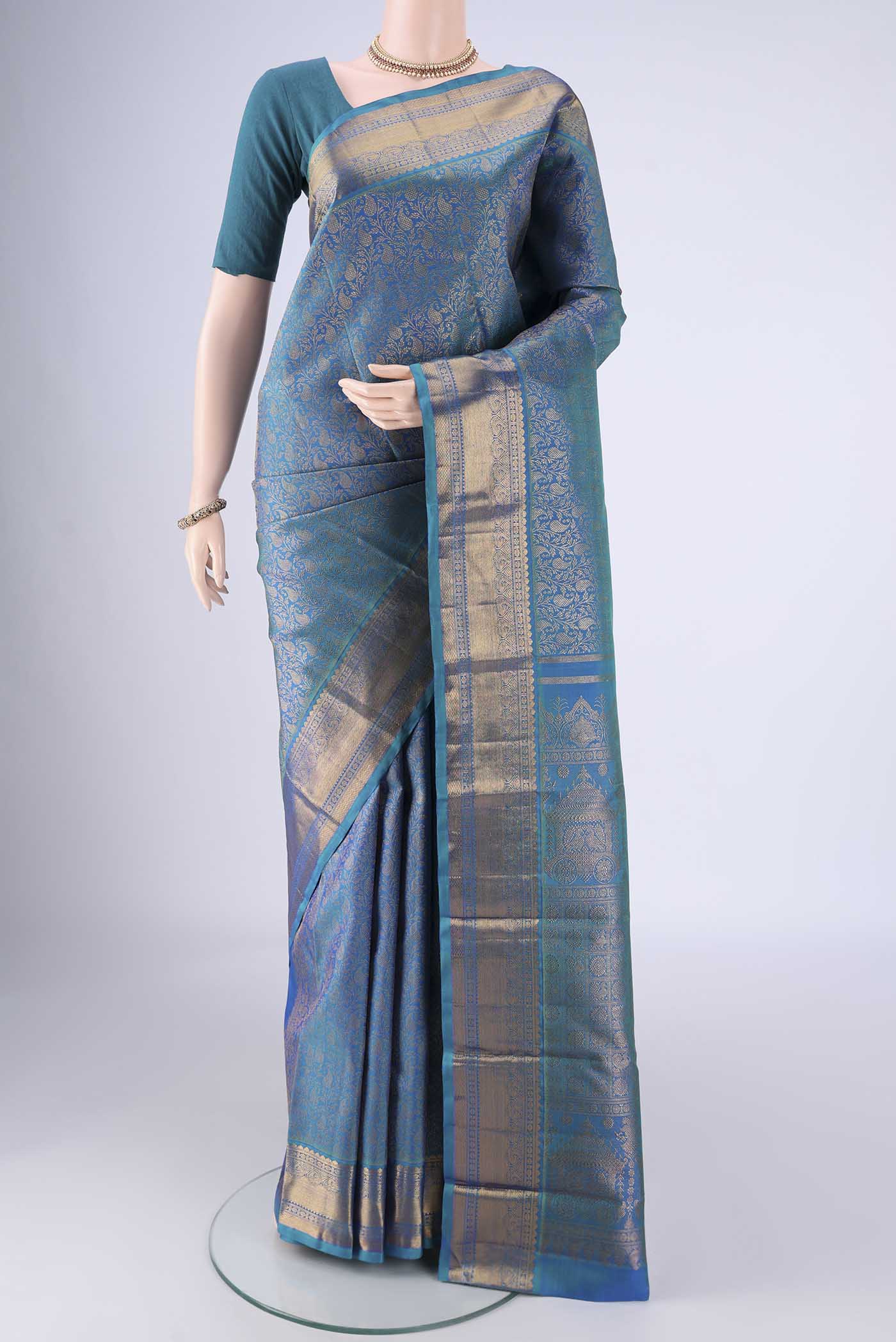 Peacock Blue Kanchipuram Silk Saree with Zari Brocade on the body and Zari Border.  displayed on a mannequin