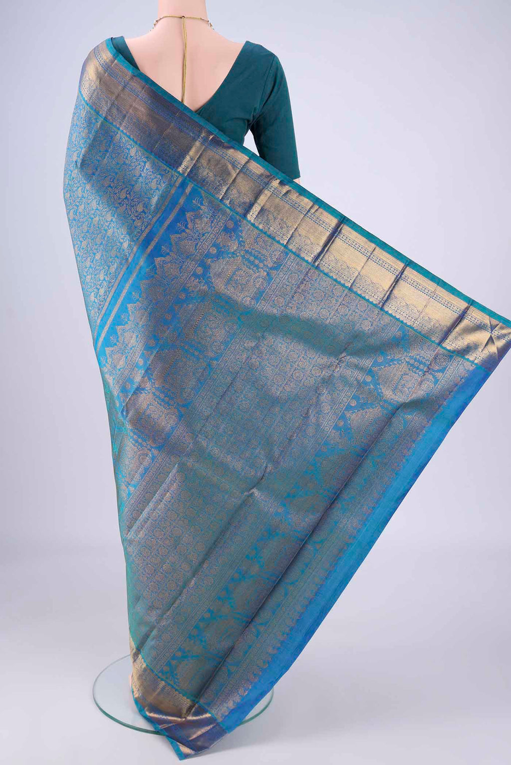 Flat view of Peacock Blue Kanchipuram Silk Saree with Zari Brocade on the body and Zari Border. 