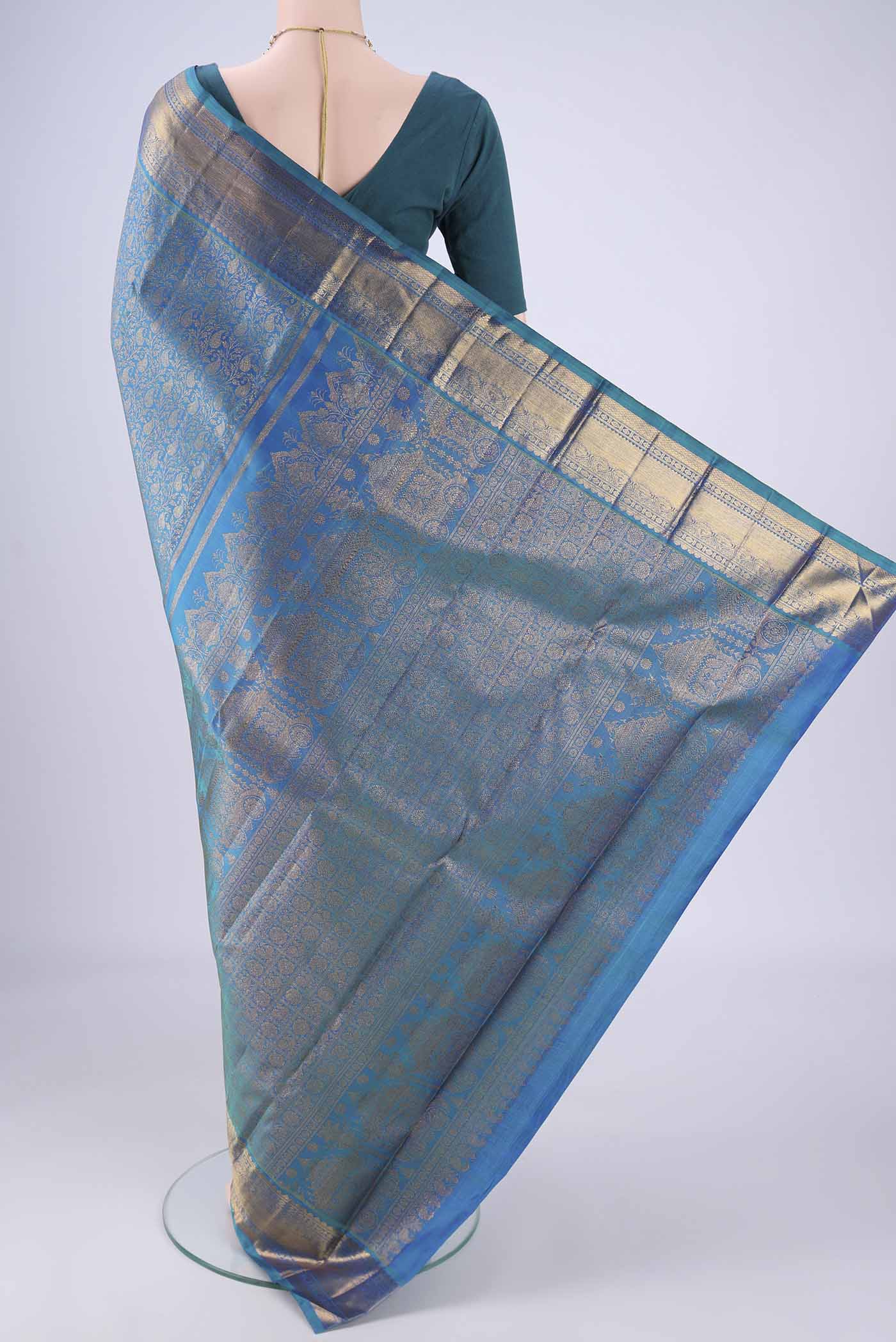 Flat view of Peacock Blue Kanchipuram Silk Saree with Zari Brocade on the body and Zari Border. 