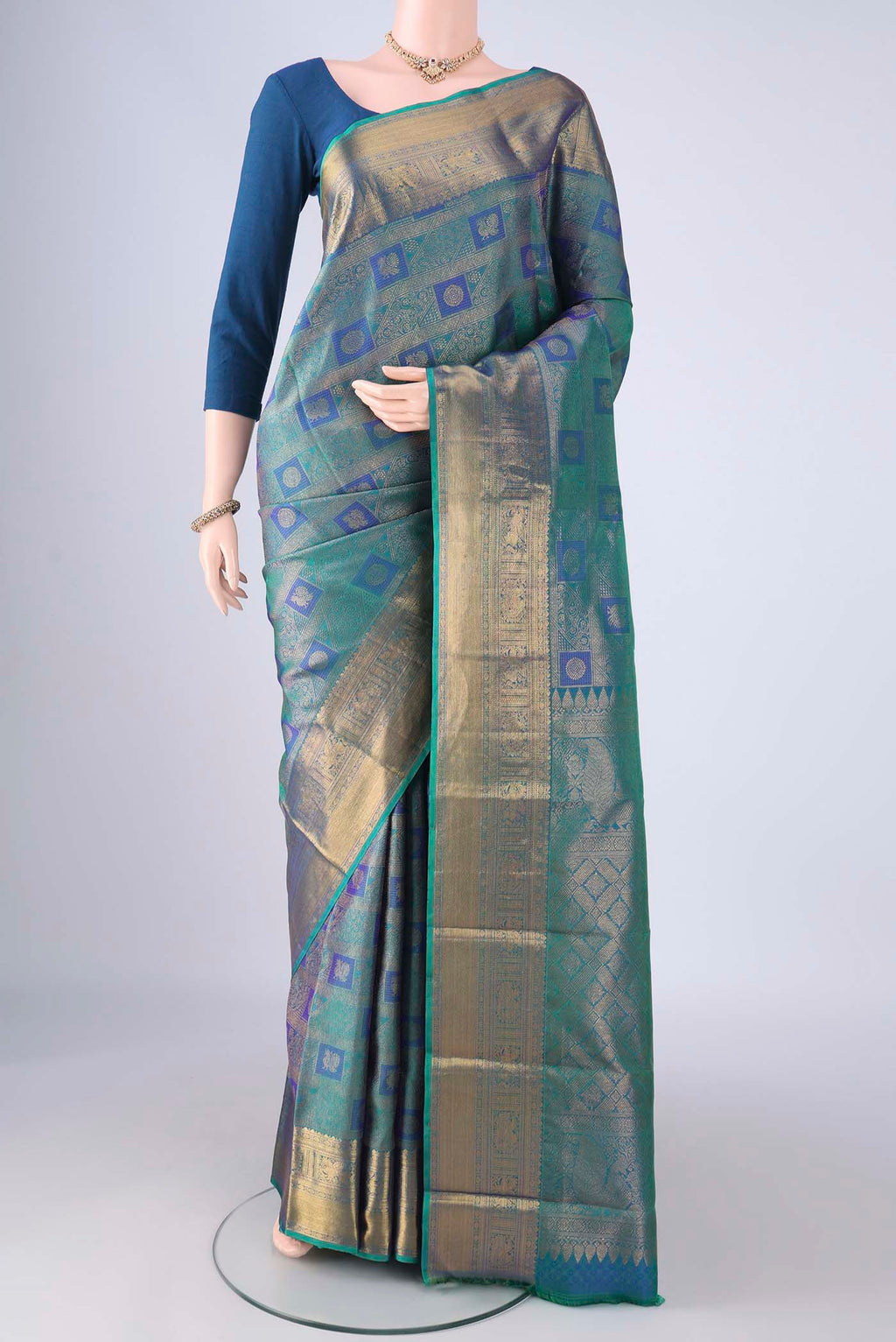 Peacock Blue Dual Tone Kanchipuram Silk Saree with Zari Brocade on the body and Zari Border.  displayed on a mannequin
