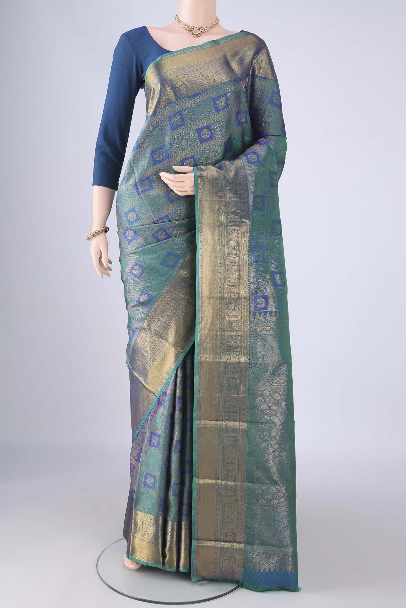 Peacock Blue Dual Tone Kanchipuram Silk Saree with Zari Brocade on the body and Zari Border.  displayed on a mannequin