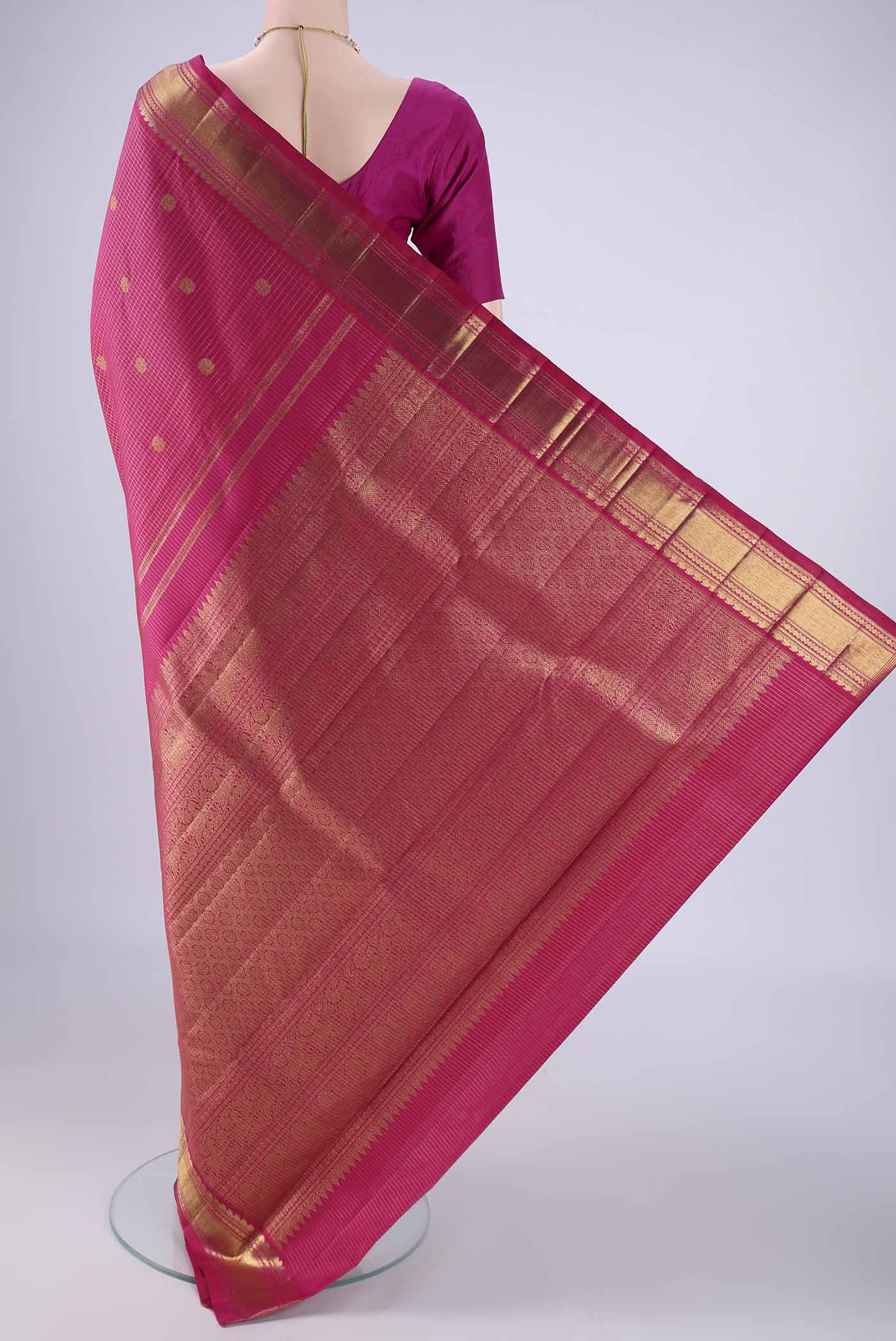 Flat view of Rani Pink Kanchipuram Silk Saree with Checked design on the body and Zari Border. 
