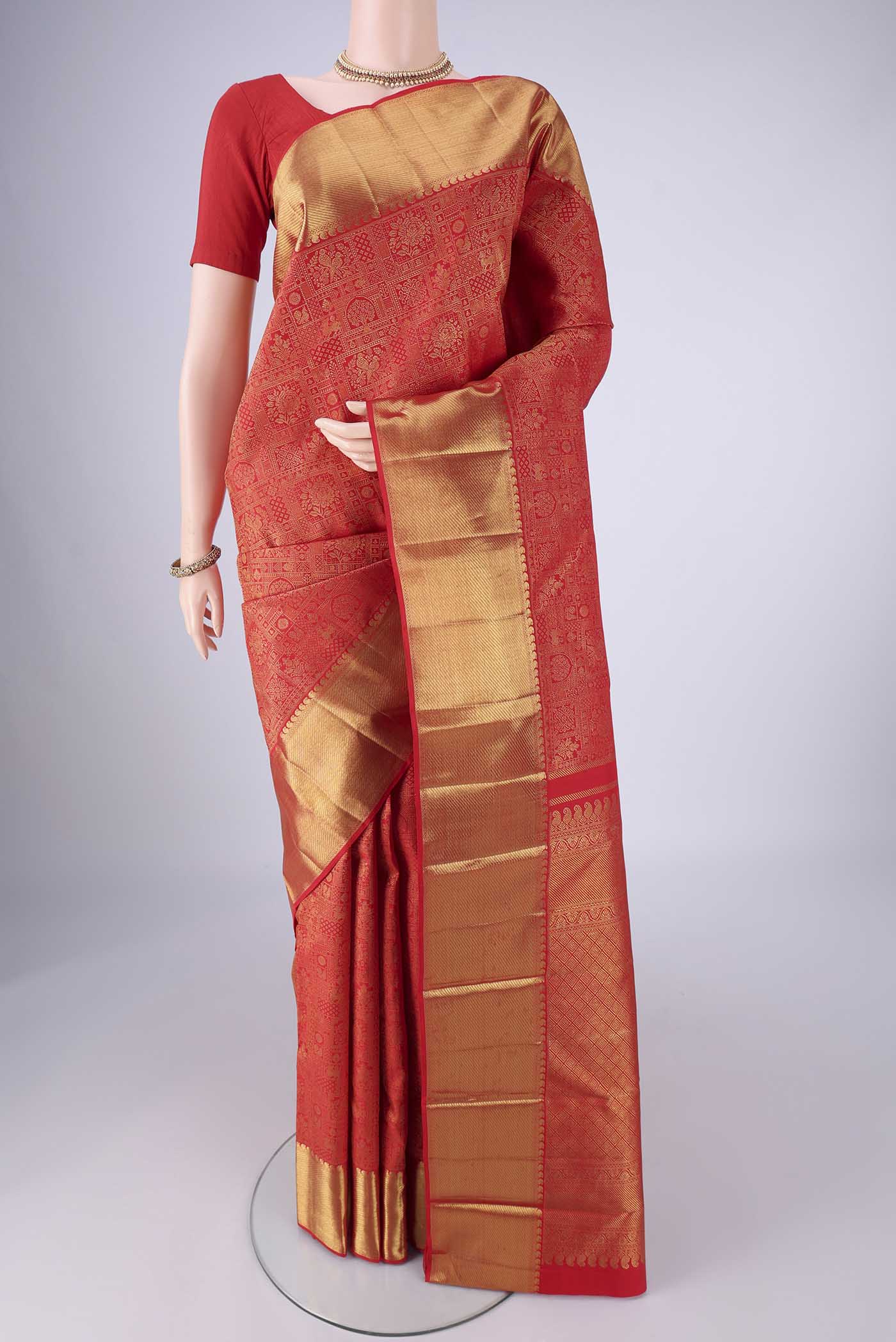 Pure Silk Pure Zari Red Kanjivaram Saree with Zari Brocade on the body and Zari Border.  displayed on a mannequin