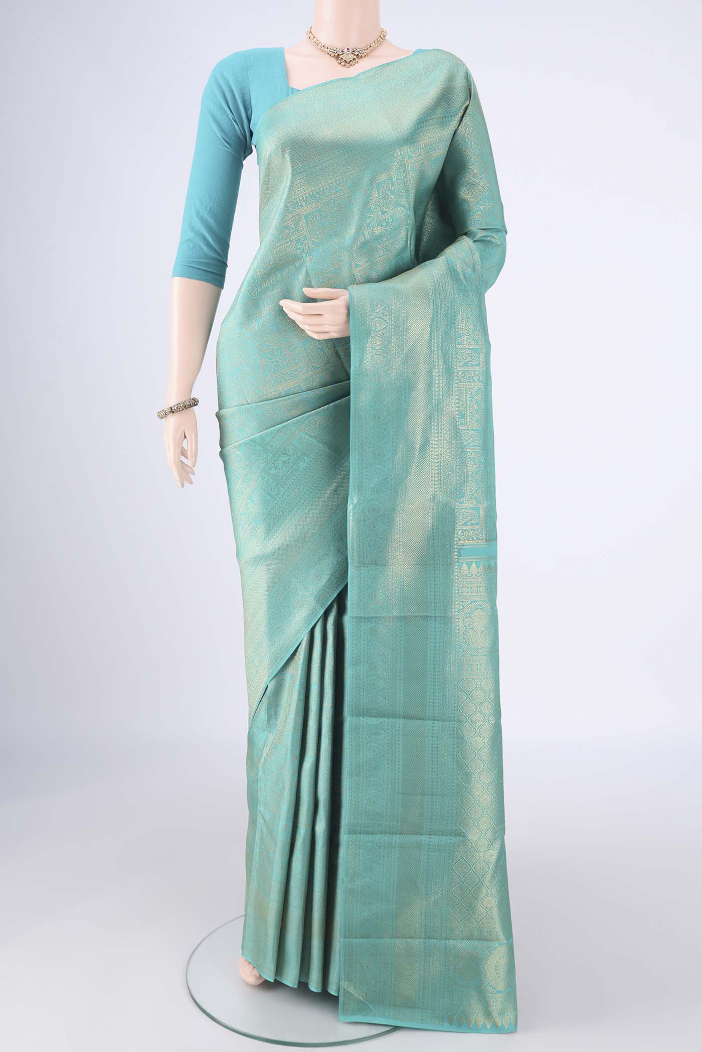 Turquoise Kanchipuram Silk Saree with Zari Brocade on the body and Zari Border.  displayed on a mannequin