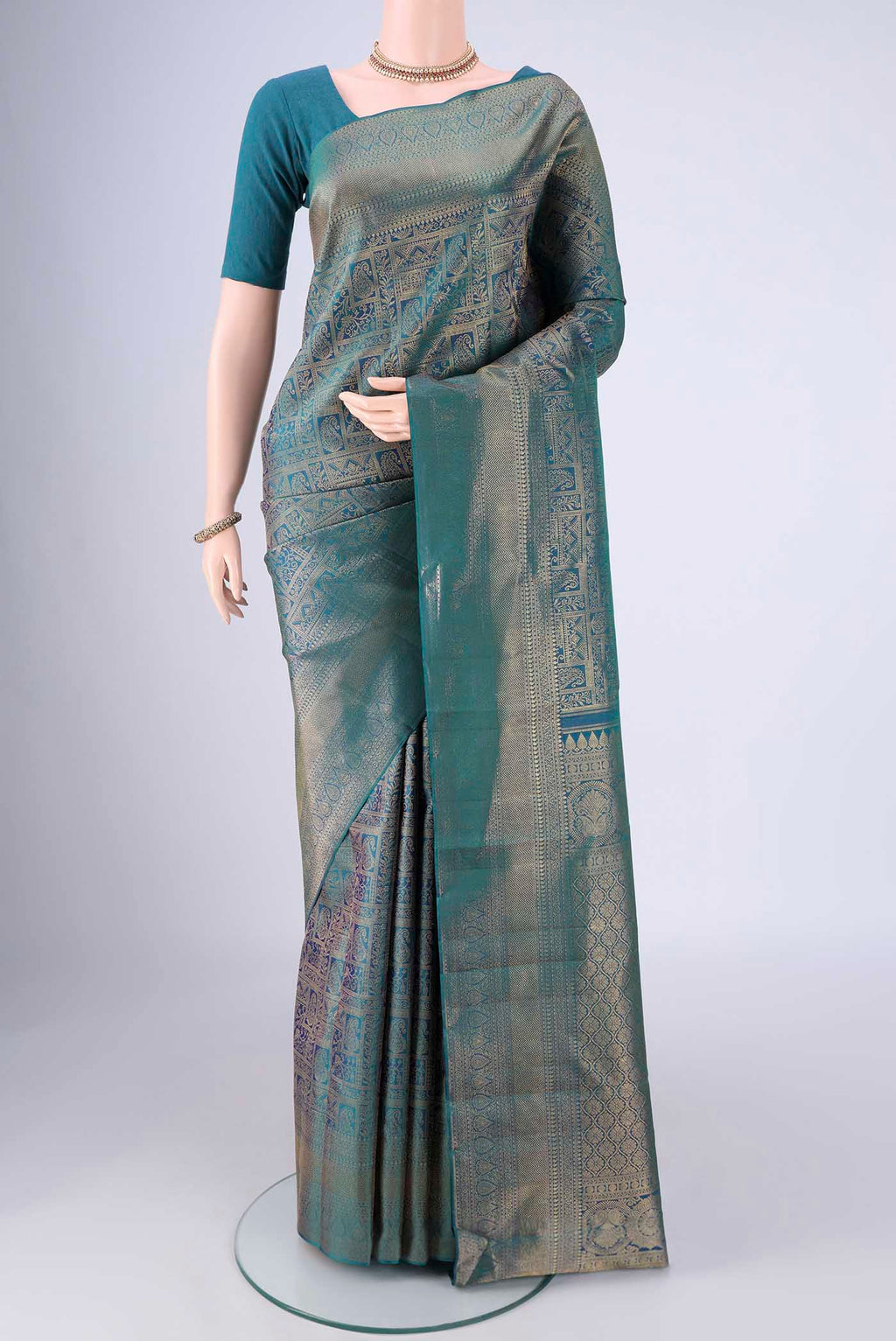 Peacock Blue Kanchipuram Silk Saree with Zari Brocade on the body and Zari Border.  displayed on a mannequin