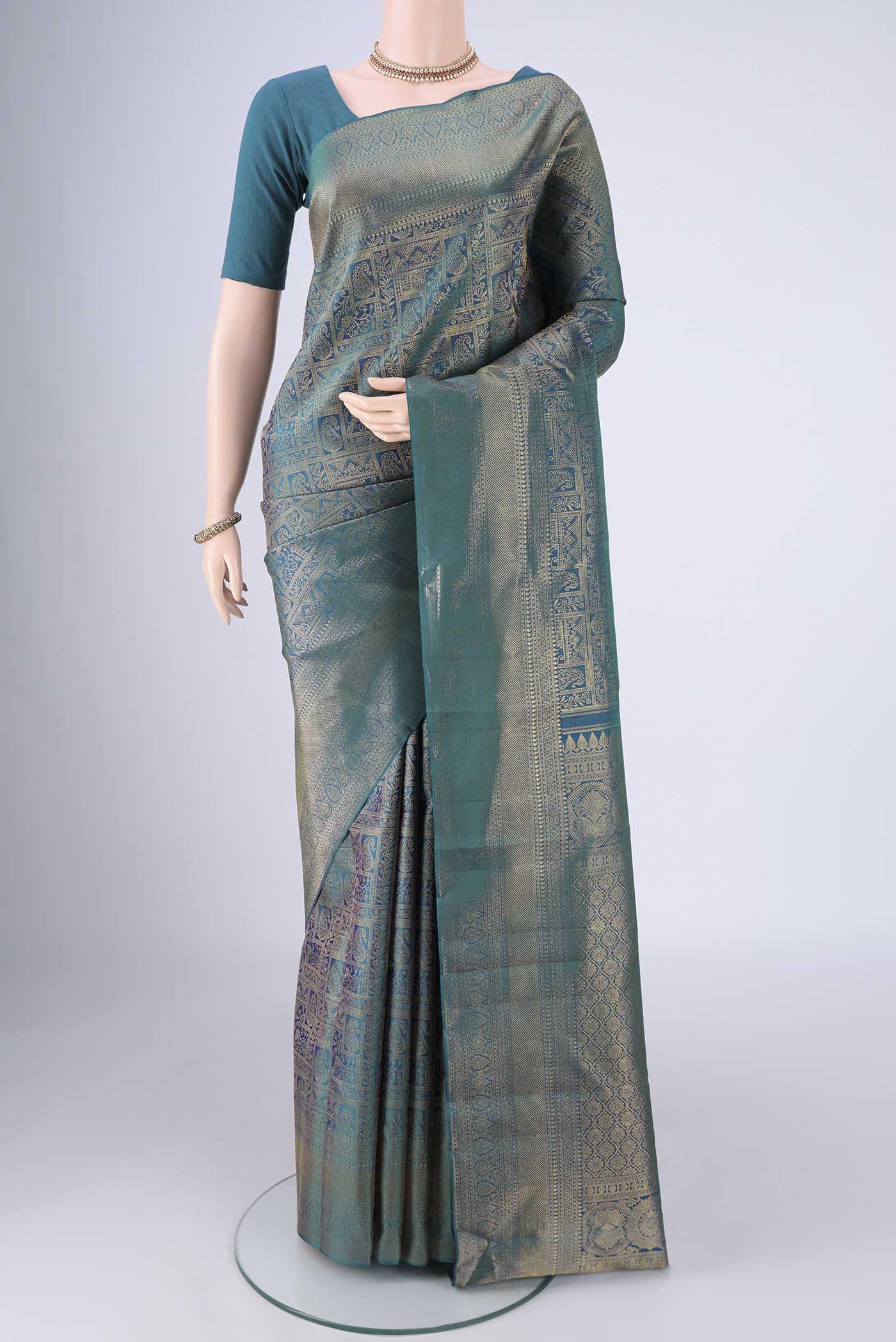 Peacock Blue Kanchipuram Silk Saree with Zari Brocade on the body and Zari Border.  displayed on a mannequin