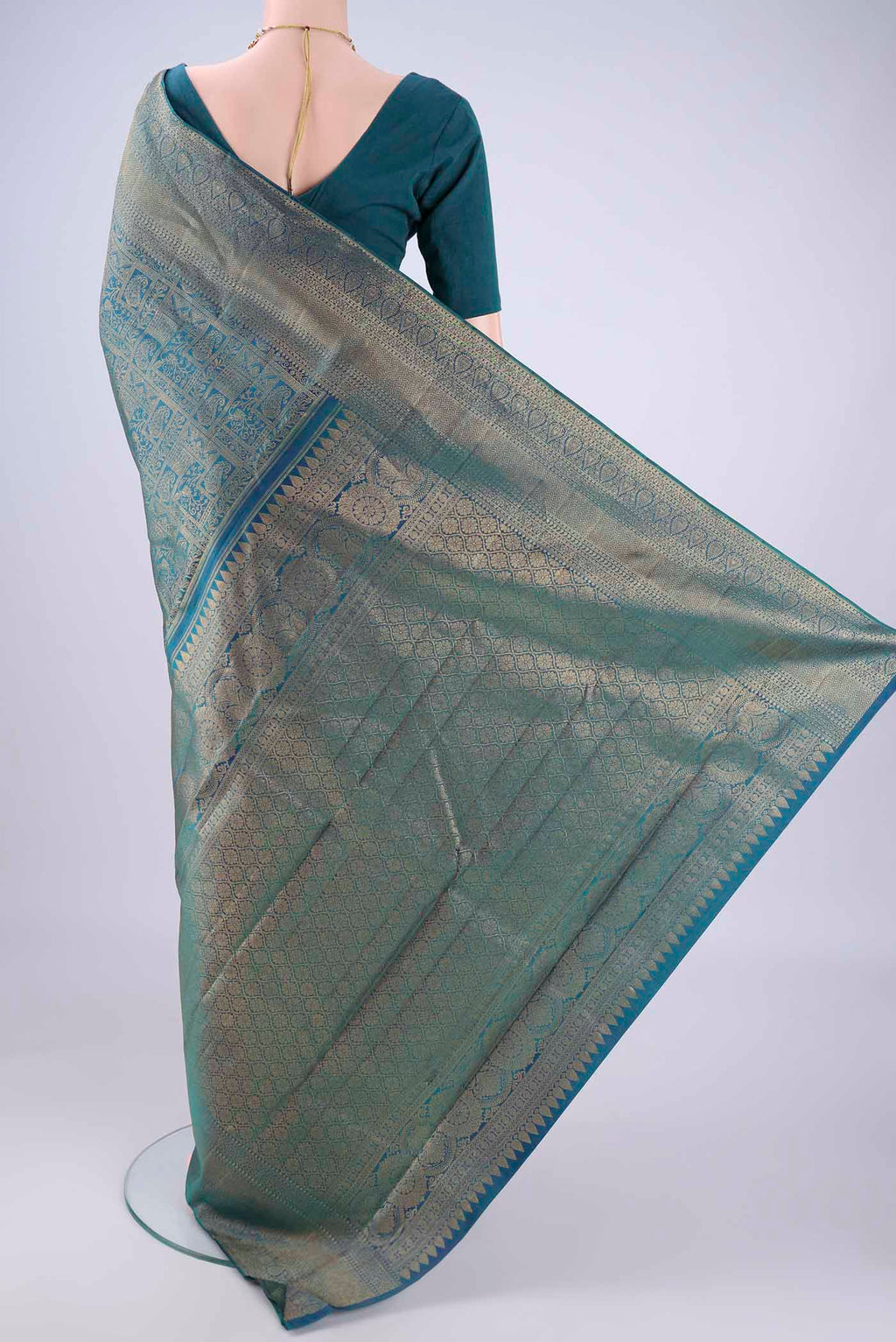 Flat view of Peacock Blue Kanchipuram Silk Saree with Zari Brocade on the body and Zari Border. 