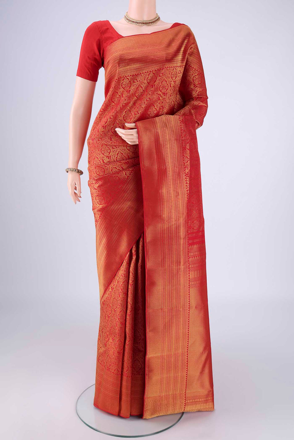 Red Kanchipuram Silk Saree with Zari Brocade on the body and Zari Border.  displayed on a mannequin