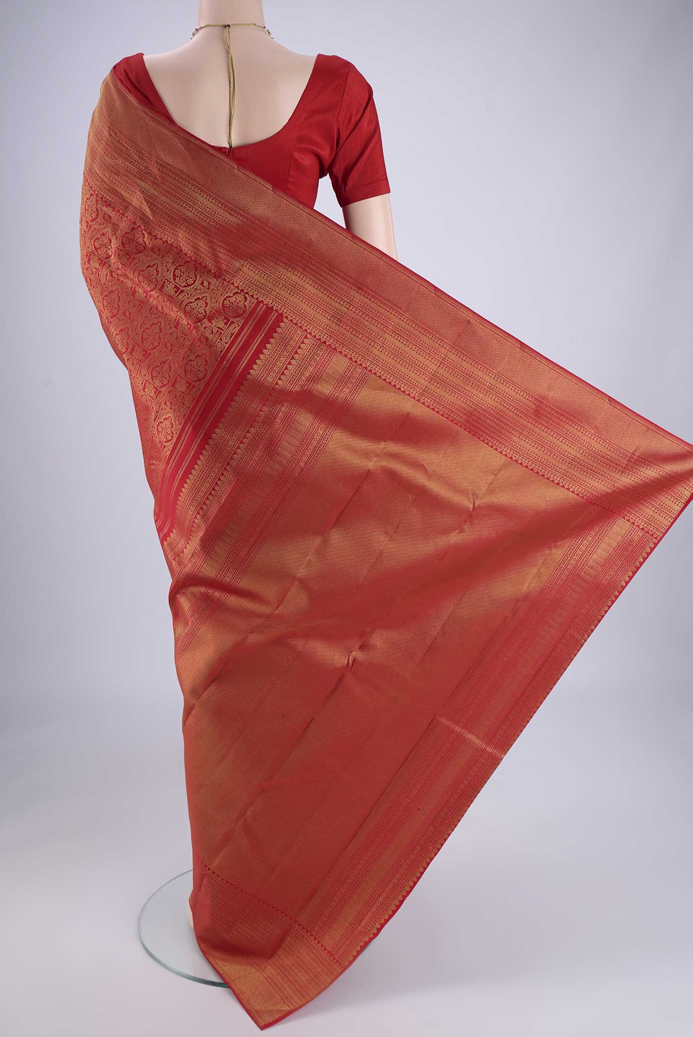 Flat view of Red Kanchipuram Silk Saree with Zari Brocade on the body and Zari Border. 