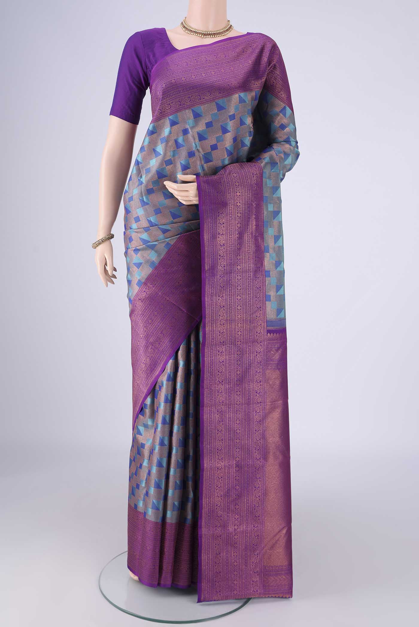 Turquoise Kanchipuram Silk Saree with Zari Brocade on the body and Zari Border.  displayed on a mannequin