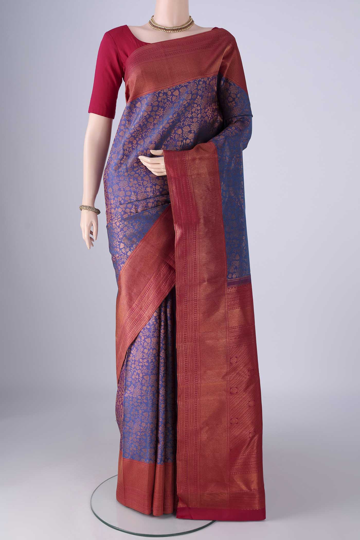 Purple Kanchipuram Silk Saree with Zari Brocade on the body and Zari Border.  displayed on a mannequin