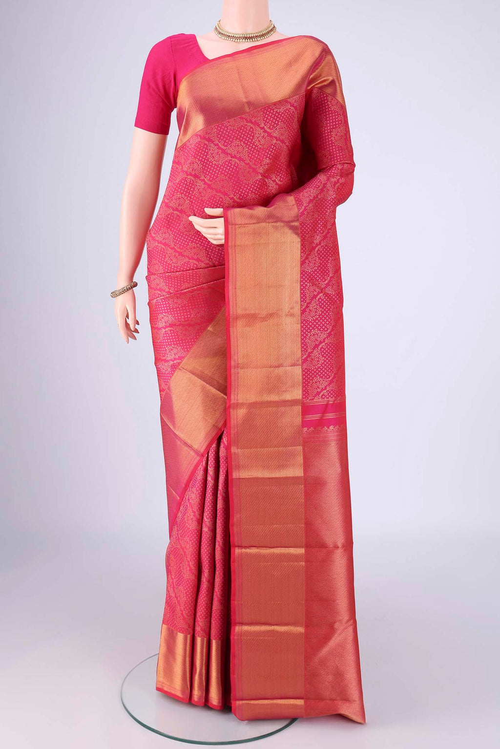 Rani Pink Kanchipuram Silk Saree with Zari Brocade on the body and Zari Border.  displayed on a mannequin