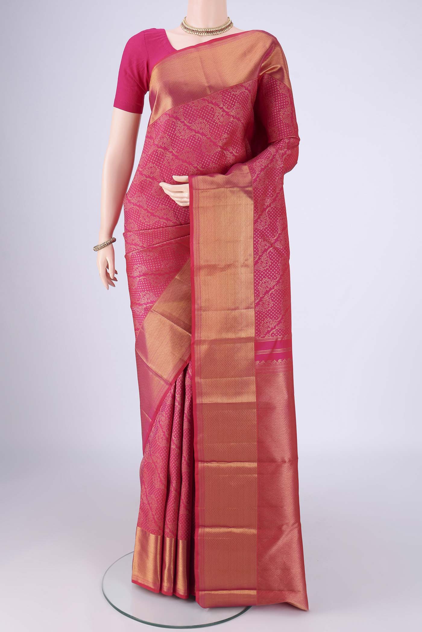Rani Pink Kanchipuram Silk Saree with Zari Brocade on the body and Zari Border.  displayed on a mannequin