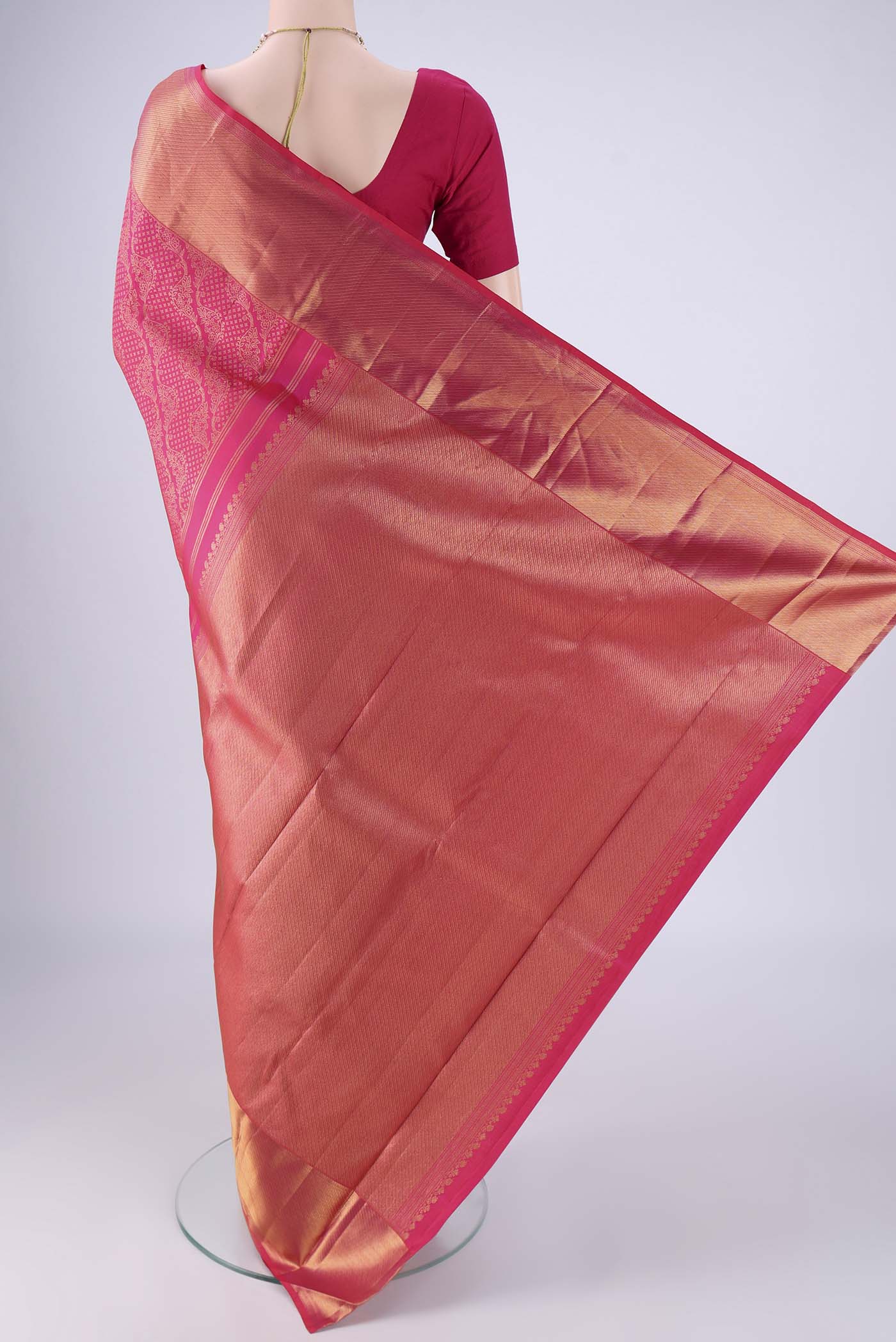 Flat view of Rani Pink Kanchipuram Silk Saree with Zari Brocade on the body and Zari Border. 