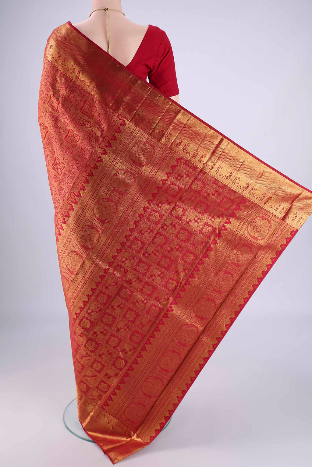 Flat view of Maroon Kanjivaram Silk Saree with Zari Brocade on the body and Zari Border. 