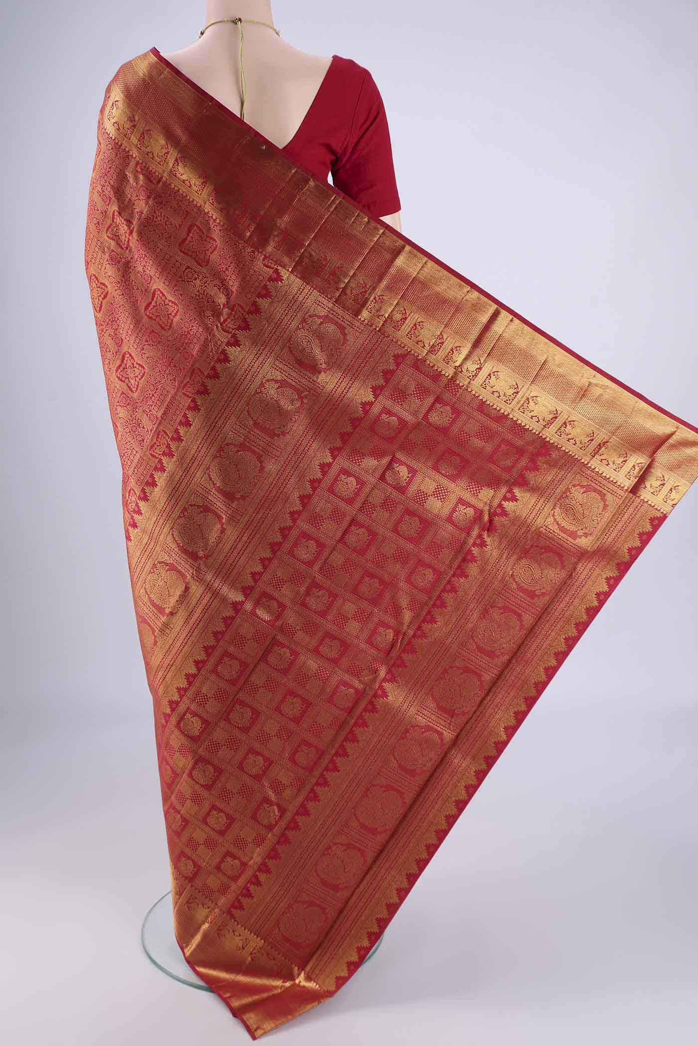 Flat view of Maroon Kanjivaram Silk Saree with Zari Brocade on the body and Zari Border. 