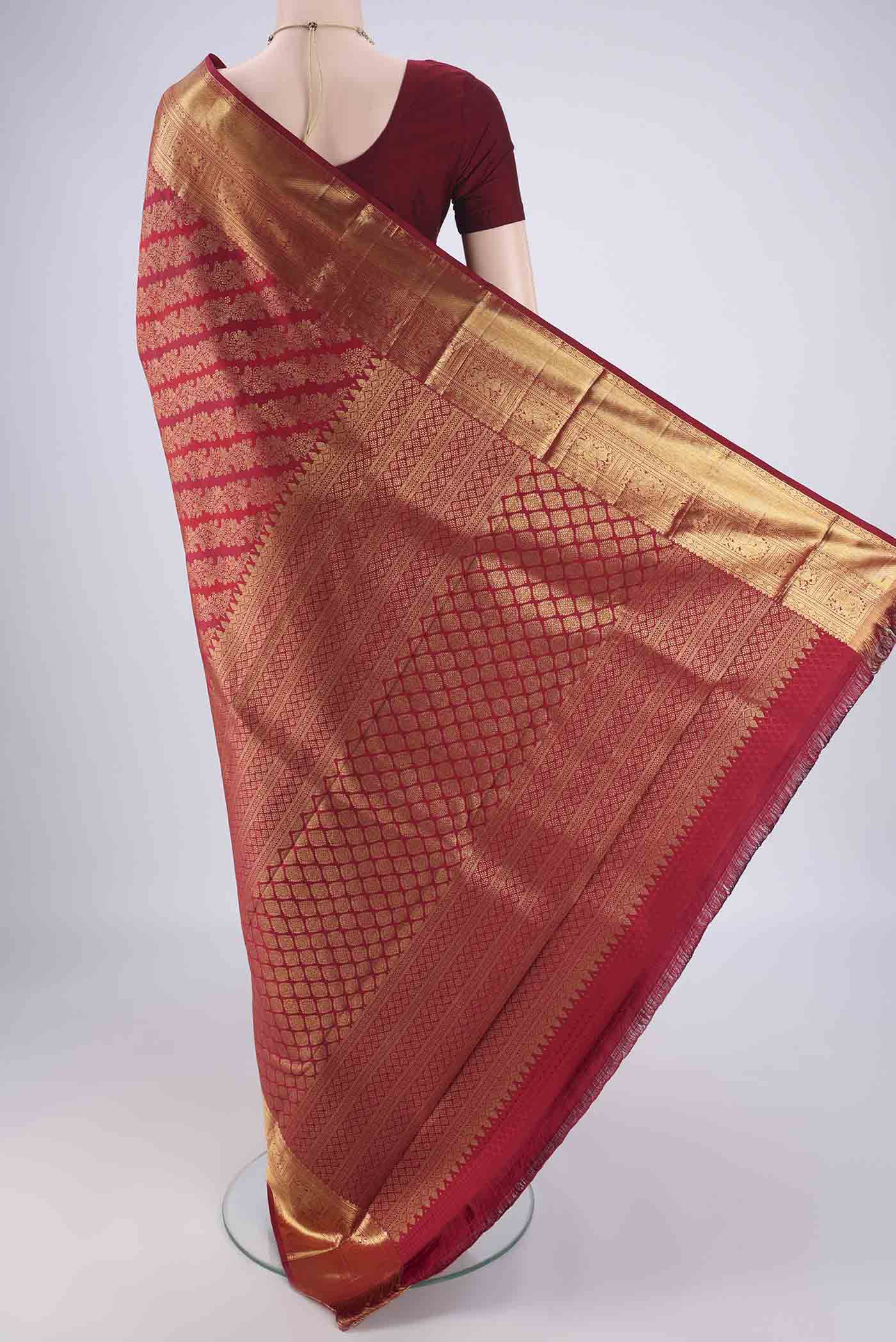 Flat view of Maroon Kanjivaram Silk Saree with Zari Brocade on the body and Zari Border. 