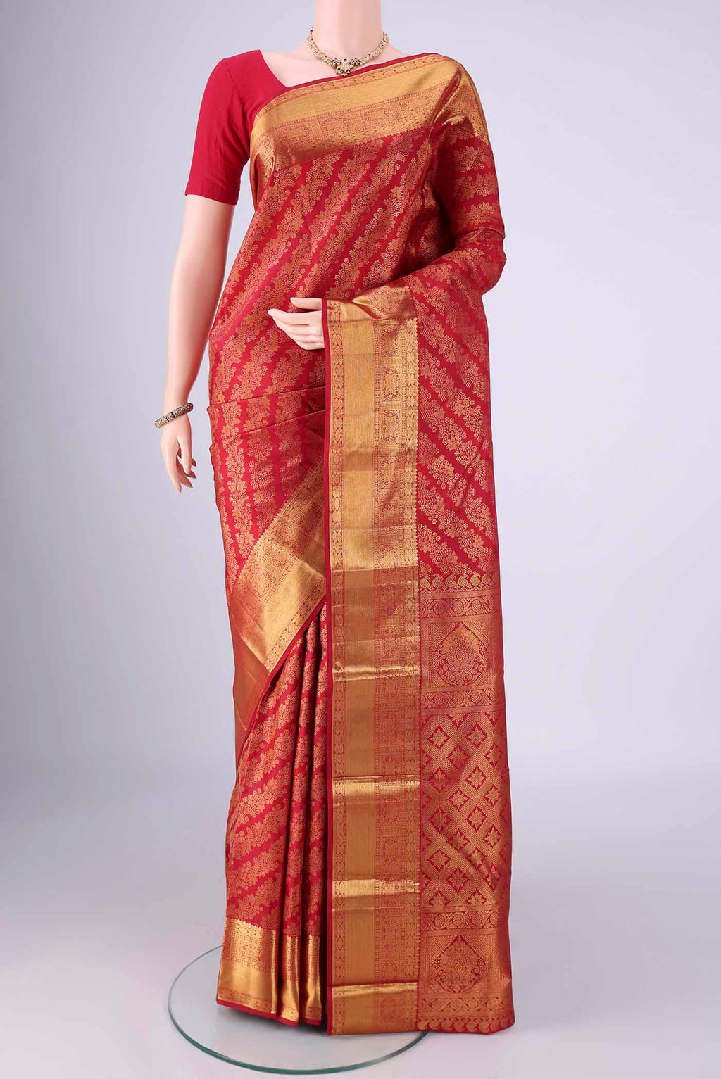 Maroon Kanjivaram Silk Saree with Zari Brocade on the body and Zari Border.  displayed on a mannequin