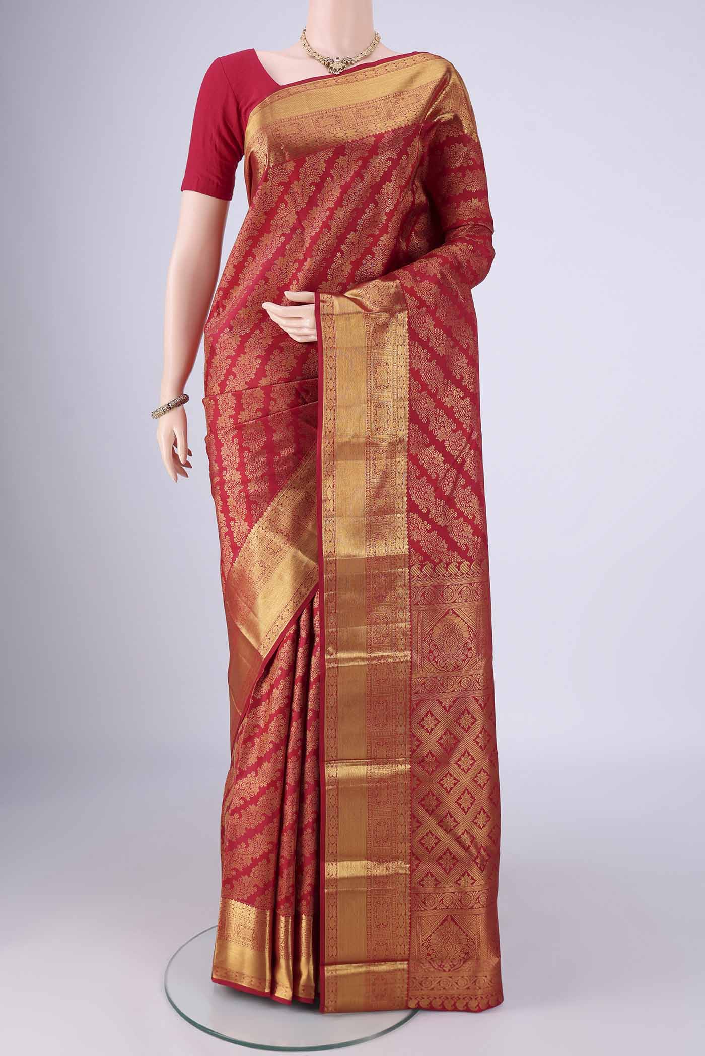 Maroon Kanjivaram Silk Saree with Zari Brocade on the body and Zari Border.  displayed on a mannequin