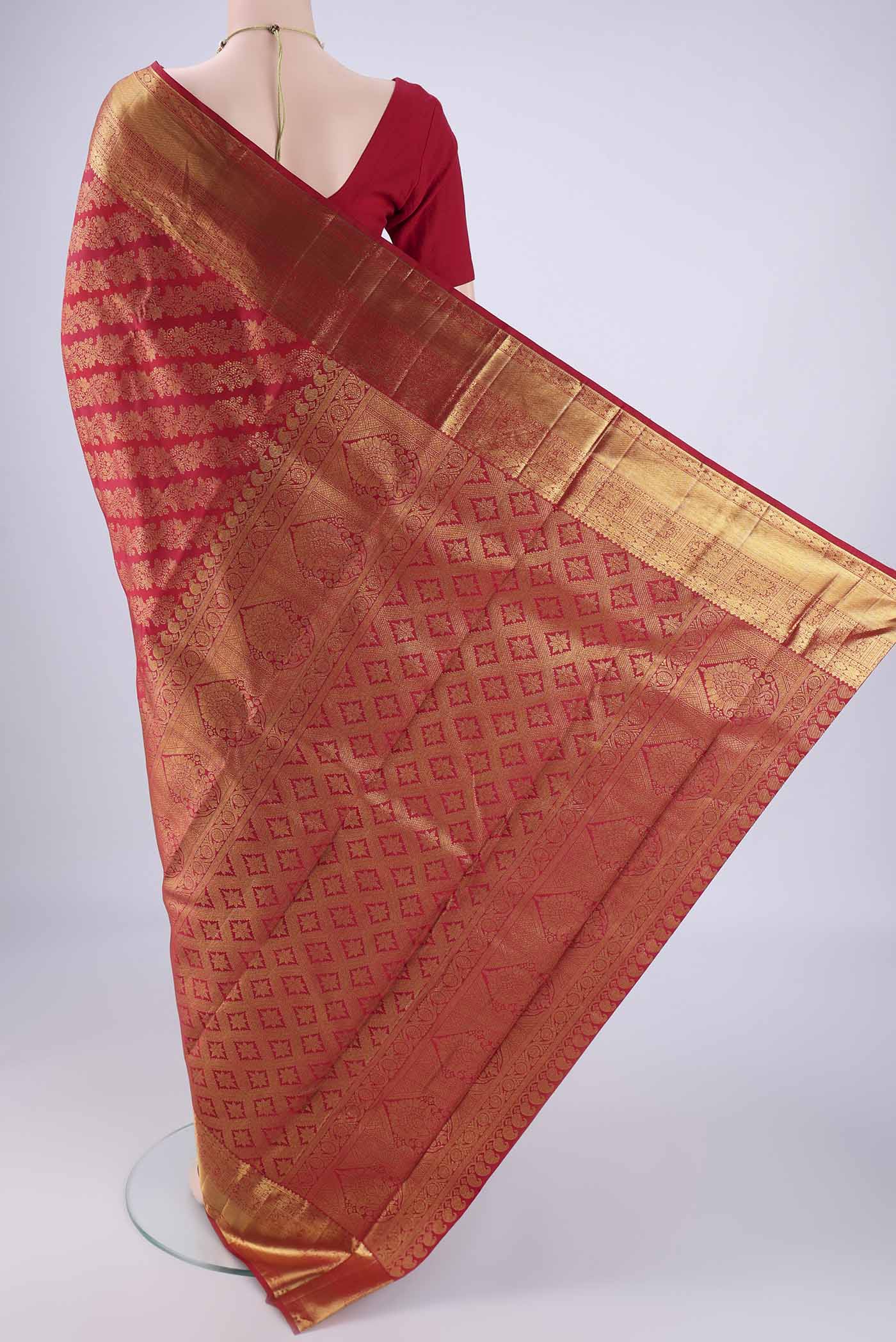 Flat view of Maroon Kanjivaram Silk Saree with Zari Brocade on the body and Zari Border. 