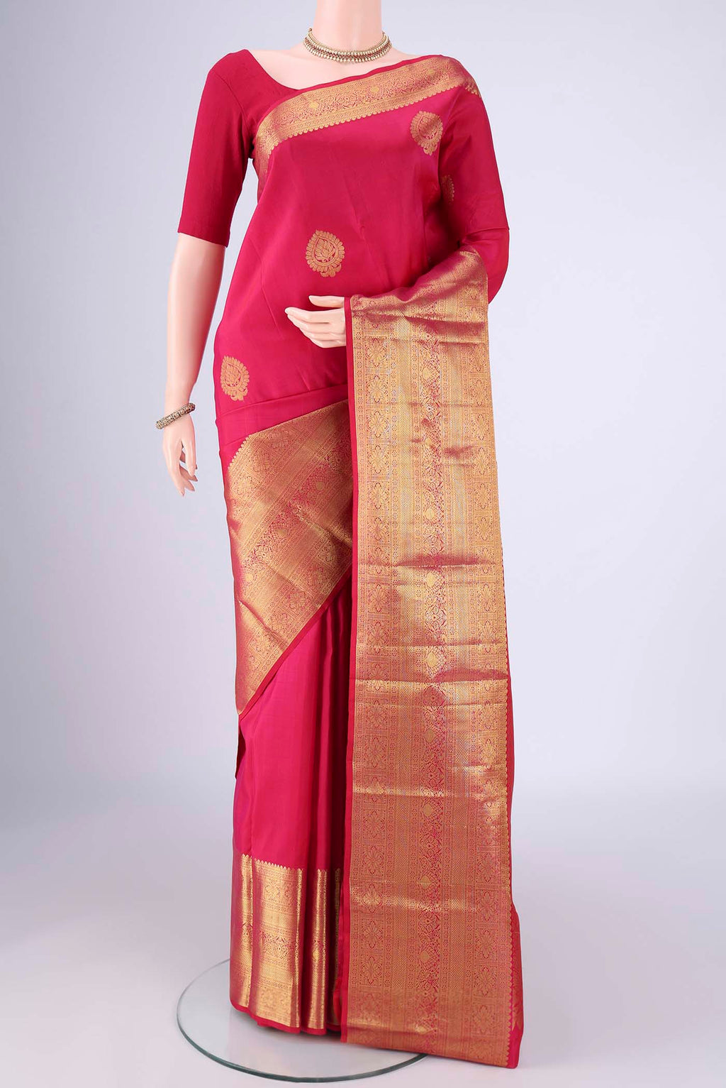 Rani Pink Dual Tone Kanchipuram Silk Saree with Zari Butta on the body and Zari Border.  displayed on a mannequin