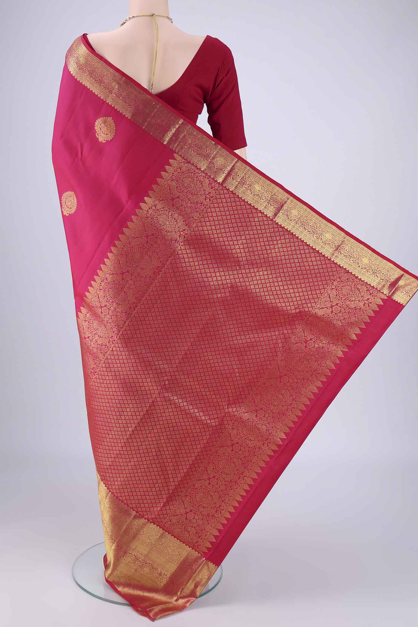 Flat view of Rani Pink Dual Tone Kanchipuram Silk Saree with Zari Butta on the body and Zari Border. 