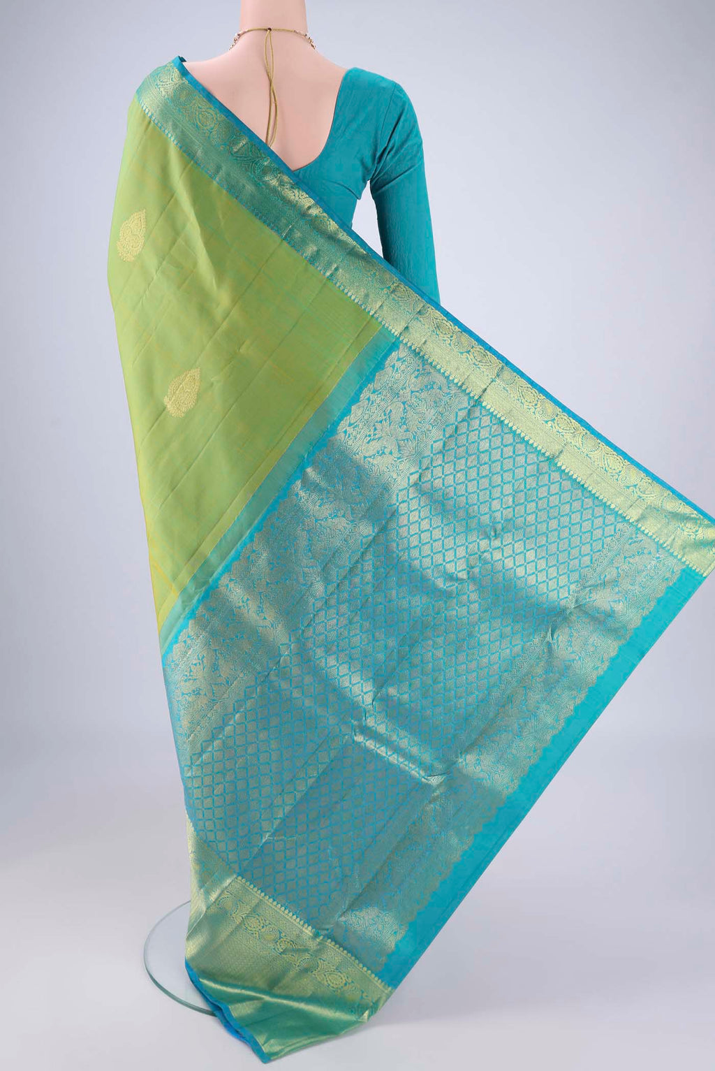 Flat view of Green Kanchipuram Silk Saree with Zari Butta on the body and Zari Border. 