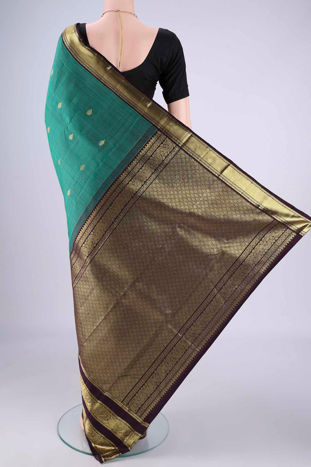 Flat view of Sea Green Kanchipuram Silk Saree with Zari Butta on the body and Zari Border. 