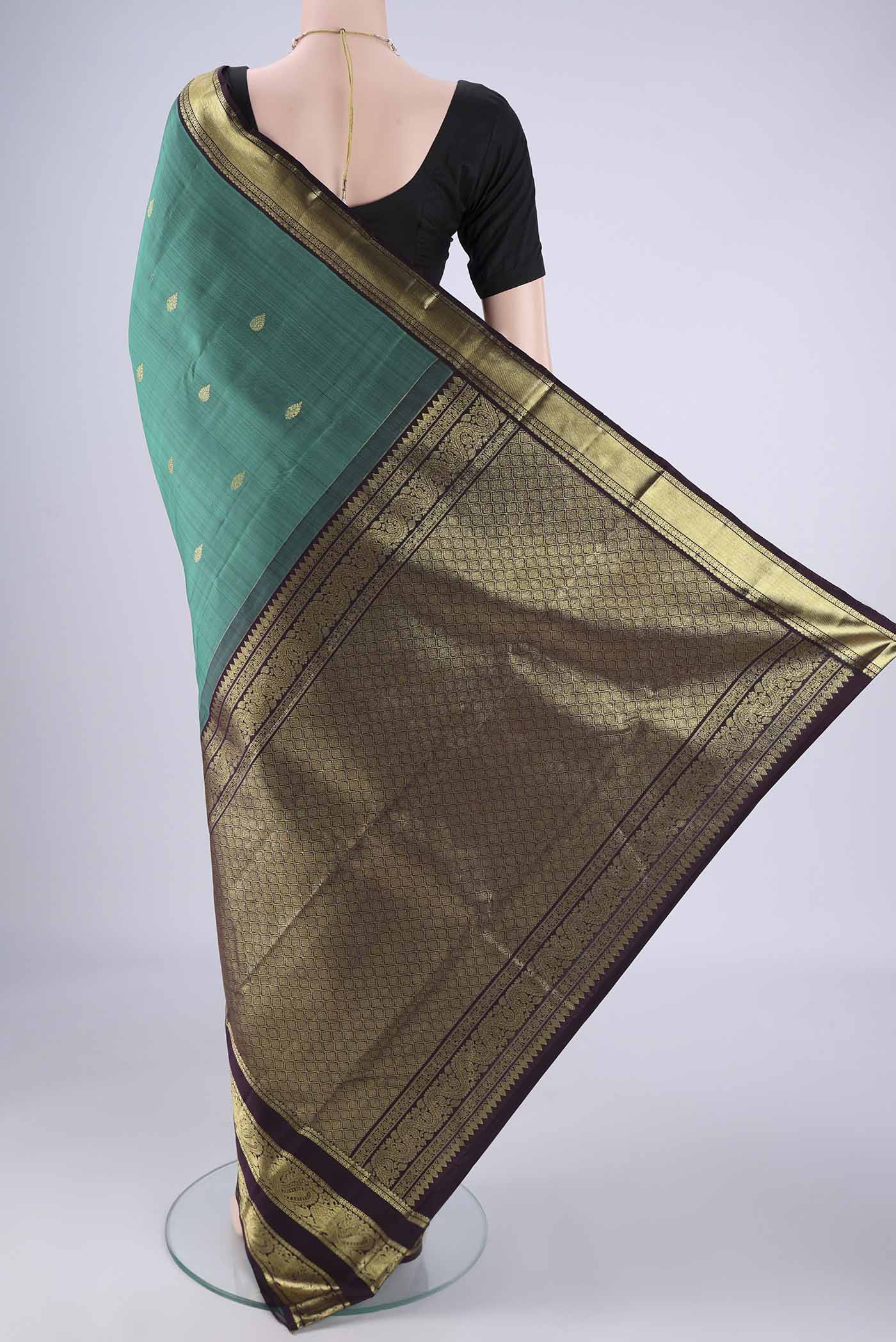 Flat view of Sea Green Kanchipuram Silk Saree with Zari Butta on the body and Zari Border. 