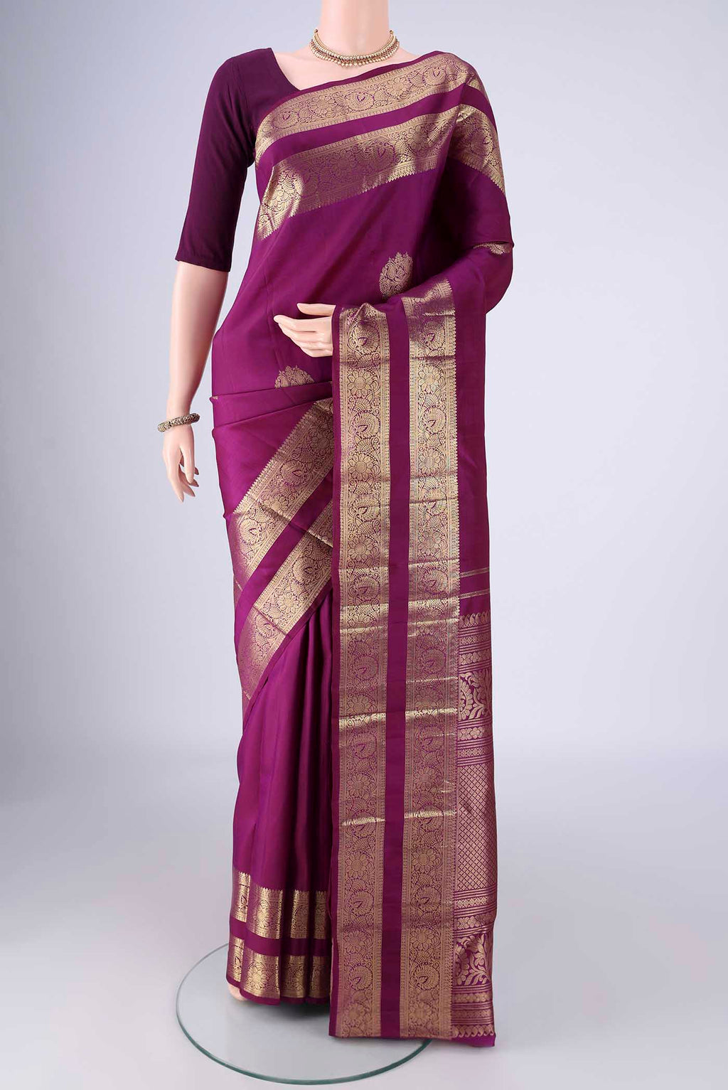 Purple Kanchipuram Silk Saree with Zari Butta on the body and Zari Border.  displayed on a mannequin