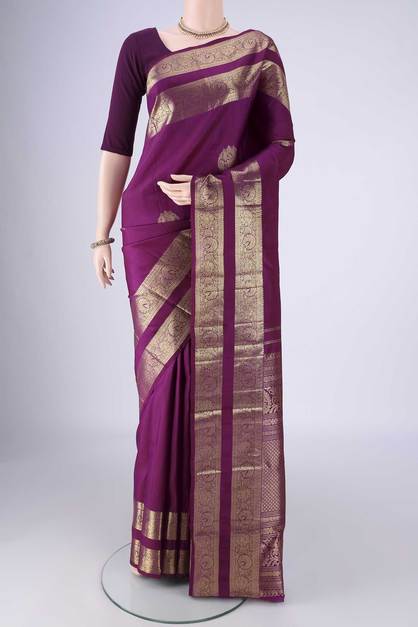 Purple Kanchipuram Silk Saree with Zari Butta on the body and Zari Border.  displayed on a mannequin