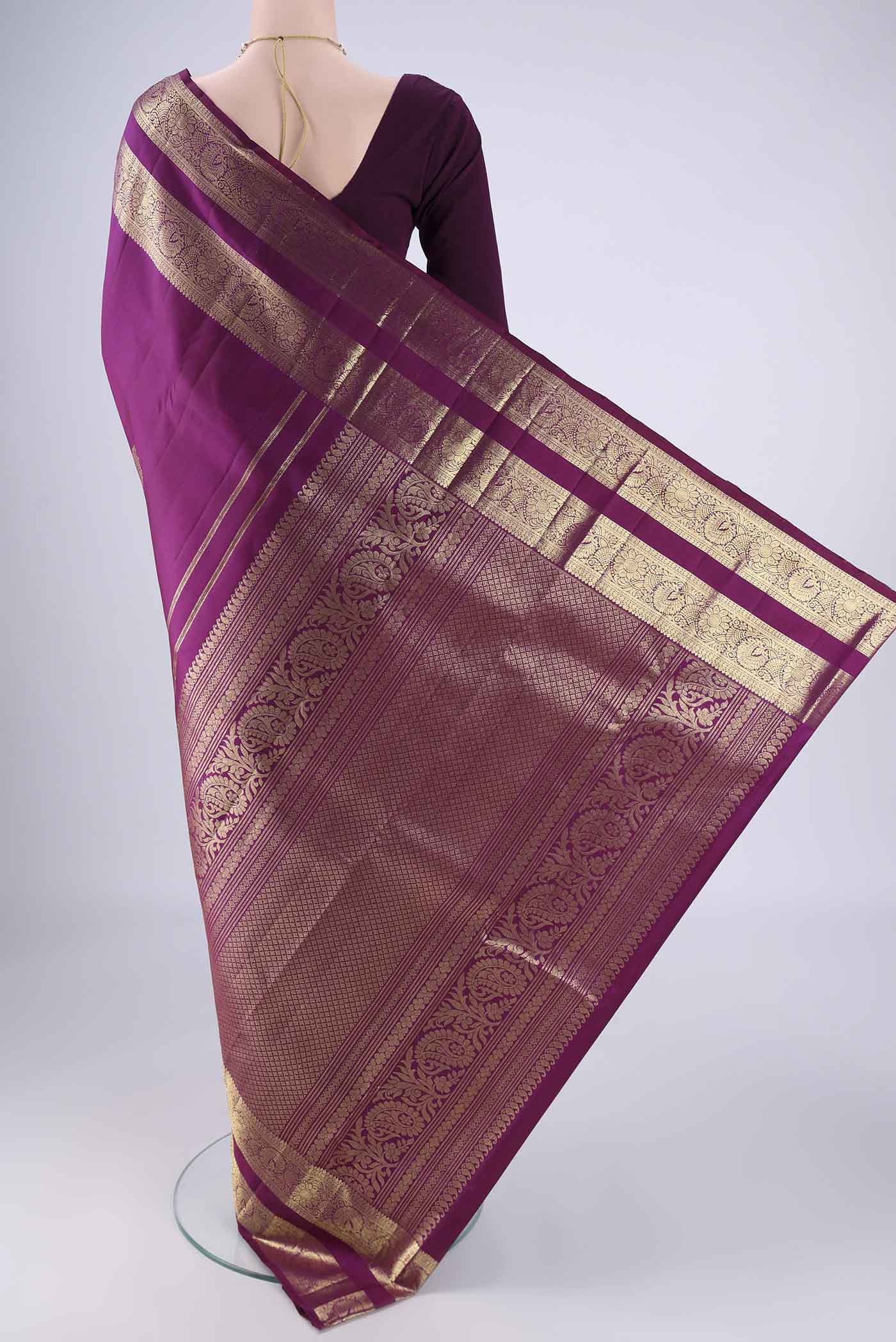 Flat view of Purple Kanchipuram Silk Saree with Zari Butta on the body and Zari Border. 