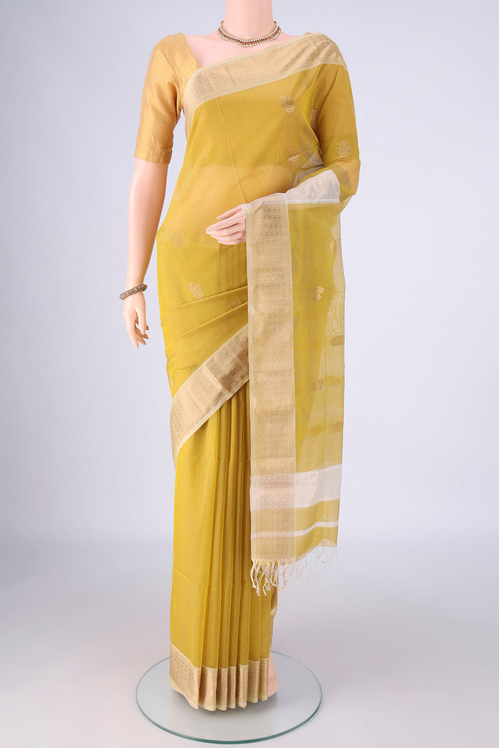 Yellow Maheshwari Silk Cotton Saree with Zari Butta on the body and Zari Border.  displayed on a mannequin